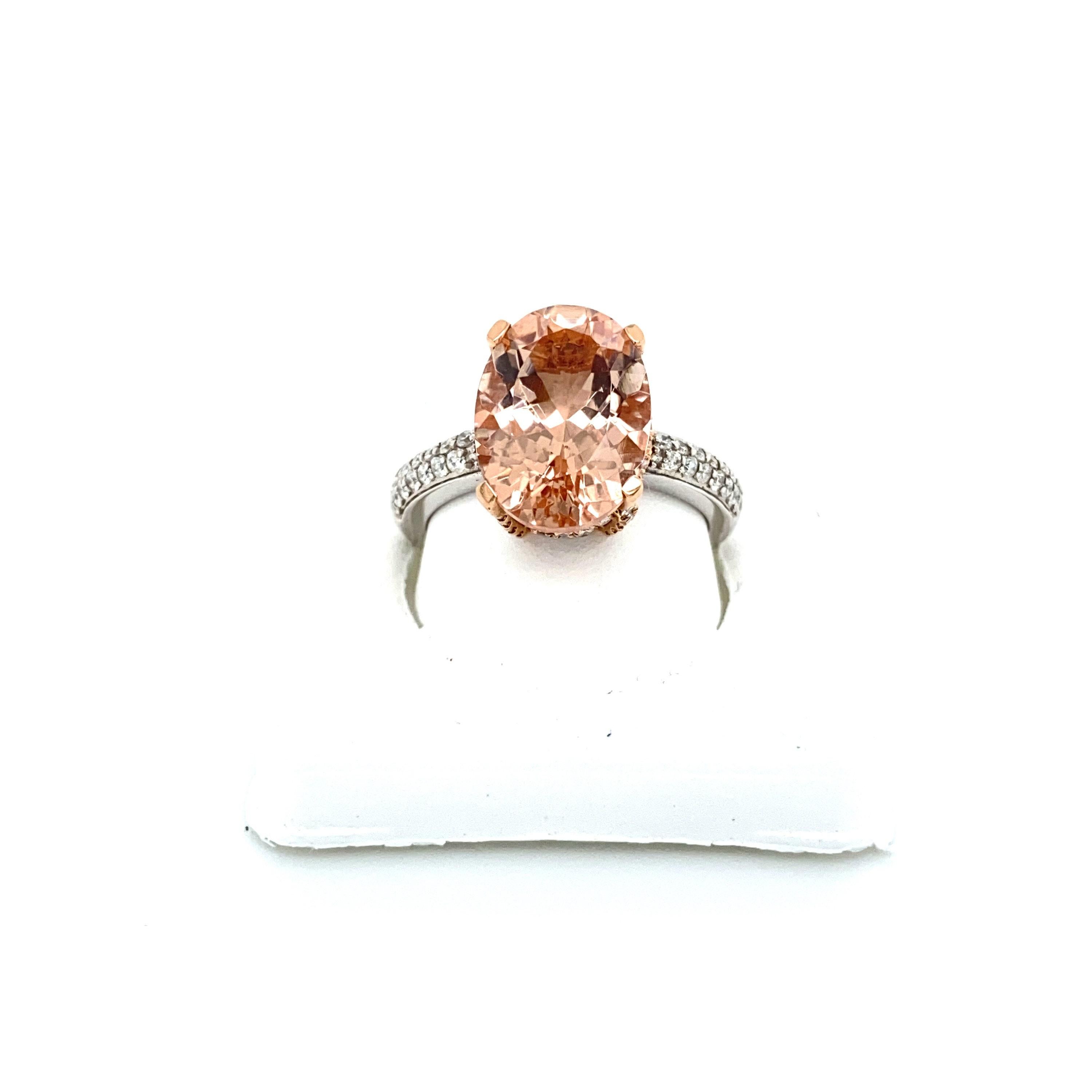 This is a magnificent natural morganite and diamond ring set in solid 14K white gold. The natural 5.51 Ct Morganite oval has an excellent peachy pink color (5.51 carats of AAA quality gem) and is set on top of a gorgeous diamond encrusted shank. The