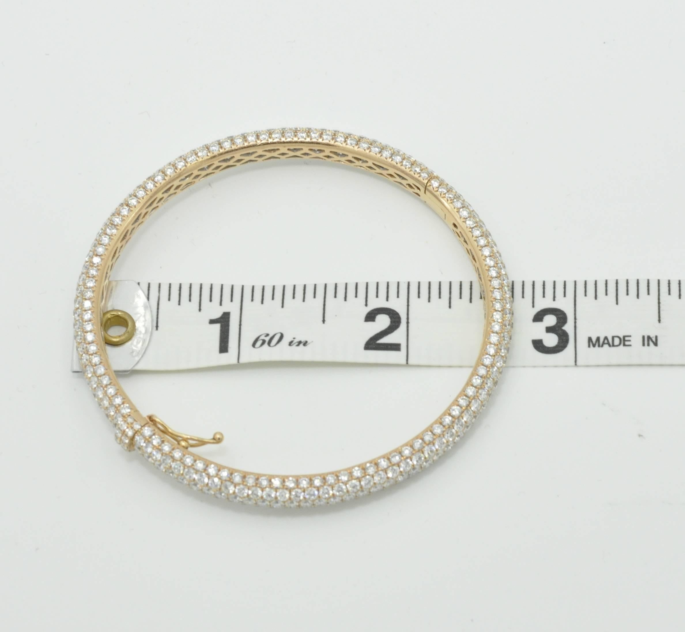 18K Rose Gold and Pave Diamond Bangle Bracelet.  Fits a traditional 7 inch sized wrist.  This bracelet has 404 stones and is G-VS1 Color and Clarity.  Total of 12.5 carats of diamonds.  There is a inside fold over safety lock.  Pre-Owned. 