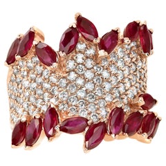 Rose gold pave set diamond ring with pear shaped rubies