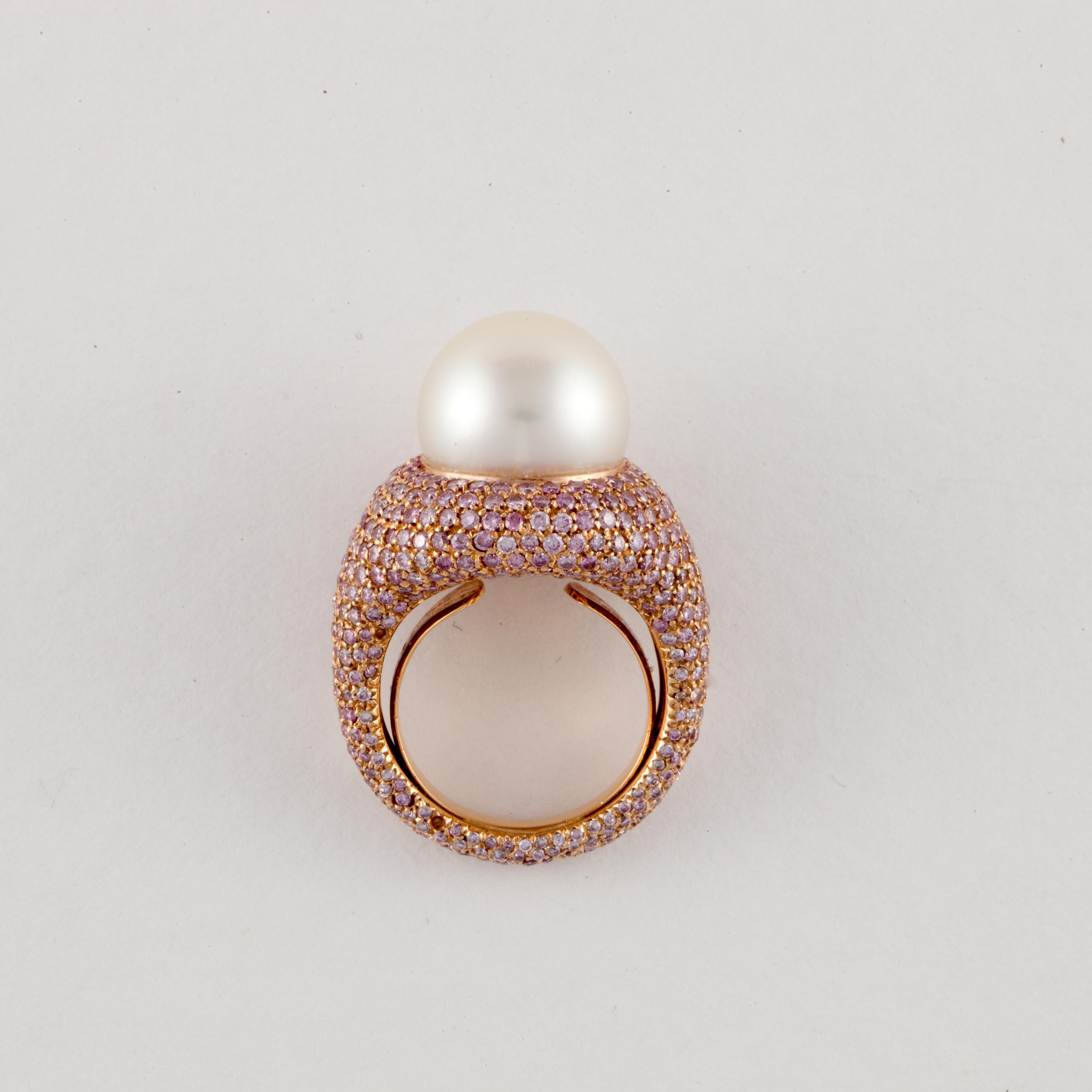 18K rose gold ring featuring a South Sea pearl with pavé-set pink round diamonds.  The pearl measures 14mm.  The ring is encrusted with round pink diamonds that go all around the ring totaling 4.75 carats.  Ring is a size 6 with butterfly insert. 