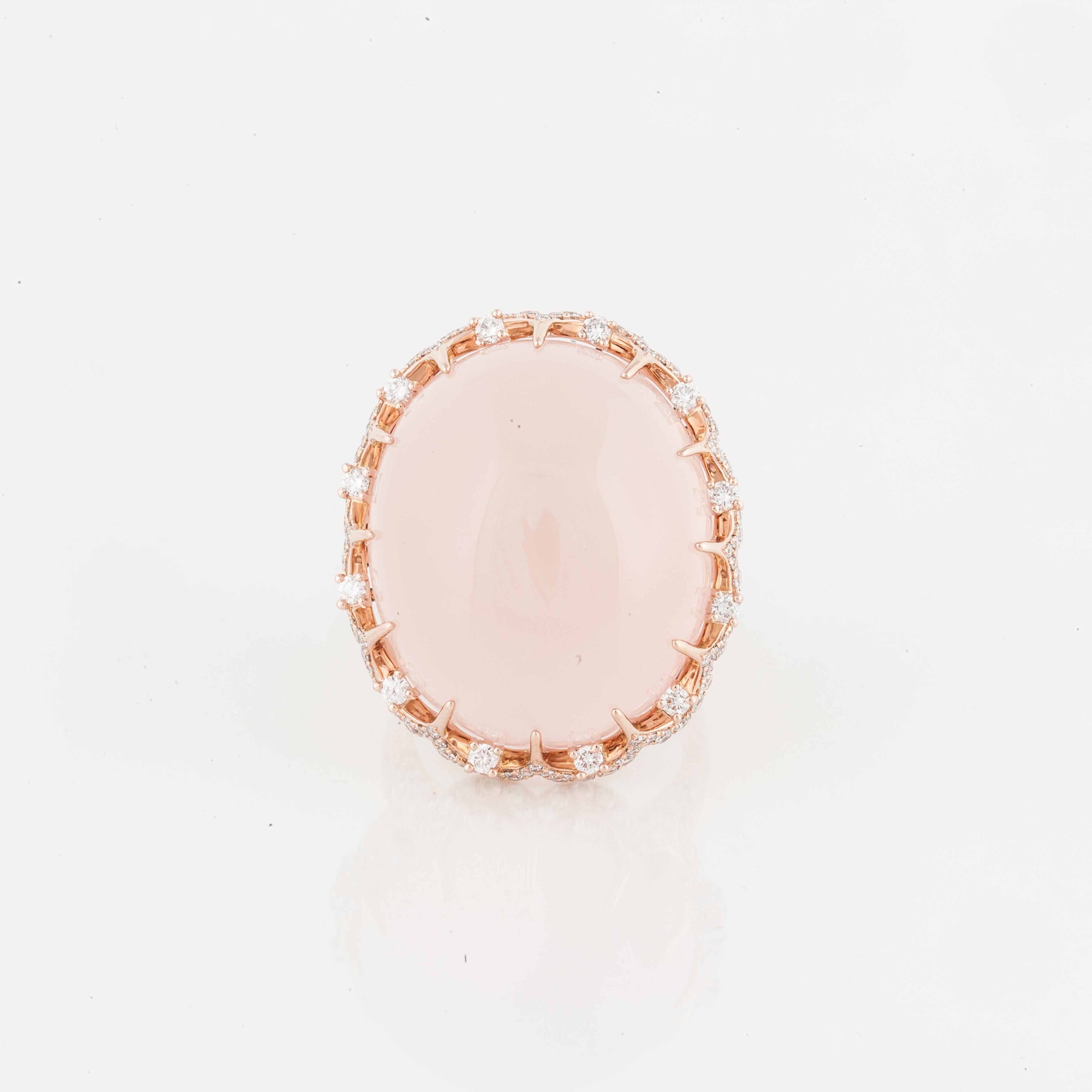 14K rose gold ring featuring a large cabochon rose quartz stone surrounded by diamonds.  There are 164 round diamonds that total 2.10 carats; G-I color and SI clarity.  The ring is currently a size 7.  Presentation area measures 1 inch by 1 1/8