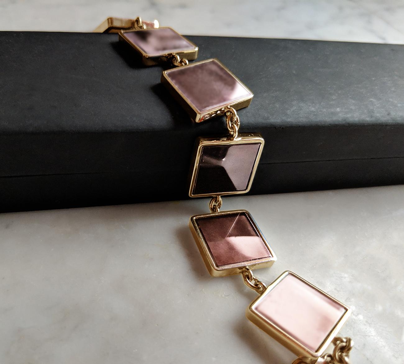 This designer jewellery bracelet is in rose gold plated sterling silver with seven 15x15x3 mm rose onyx gems. The Ink collection was featured in Harper's Bazaar UA and Vogue UA published issues.

The bracelet shines gently because of the gold and