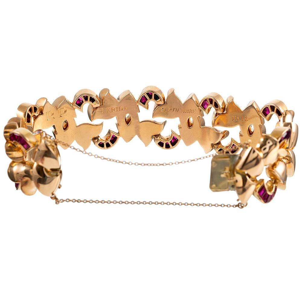 A substantial and graceful piece, made of 18 karat rose gold and designed of golden, sculpted links with sections of synthetic rubies. This piece embodies grand retro style! The piece measures 7.5 inches long, just over 1 inch wide and is fitted