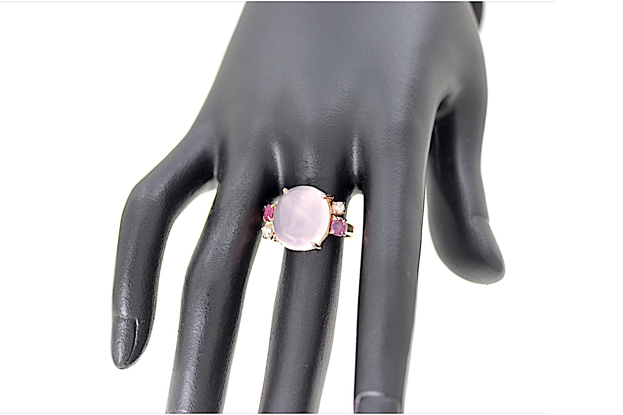Contemporary ring handcrafted in 9k rose gold in our jewelry workshop in Milan. At the center, a rose quartz cabochon is surrounded by 2 oval pink rubies and 2 round white diamonds. The oval-shaped rose quartz, cut as a cabochon, measures 14x12 mm /