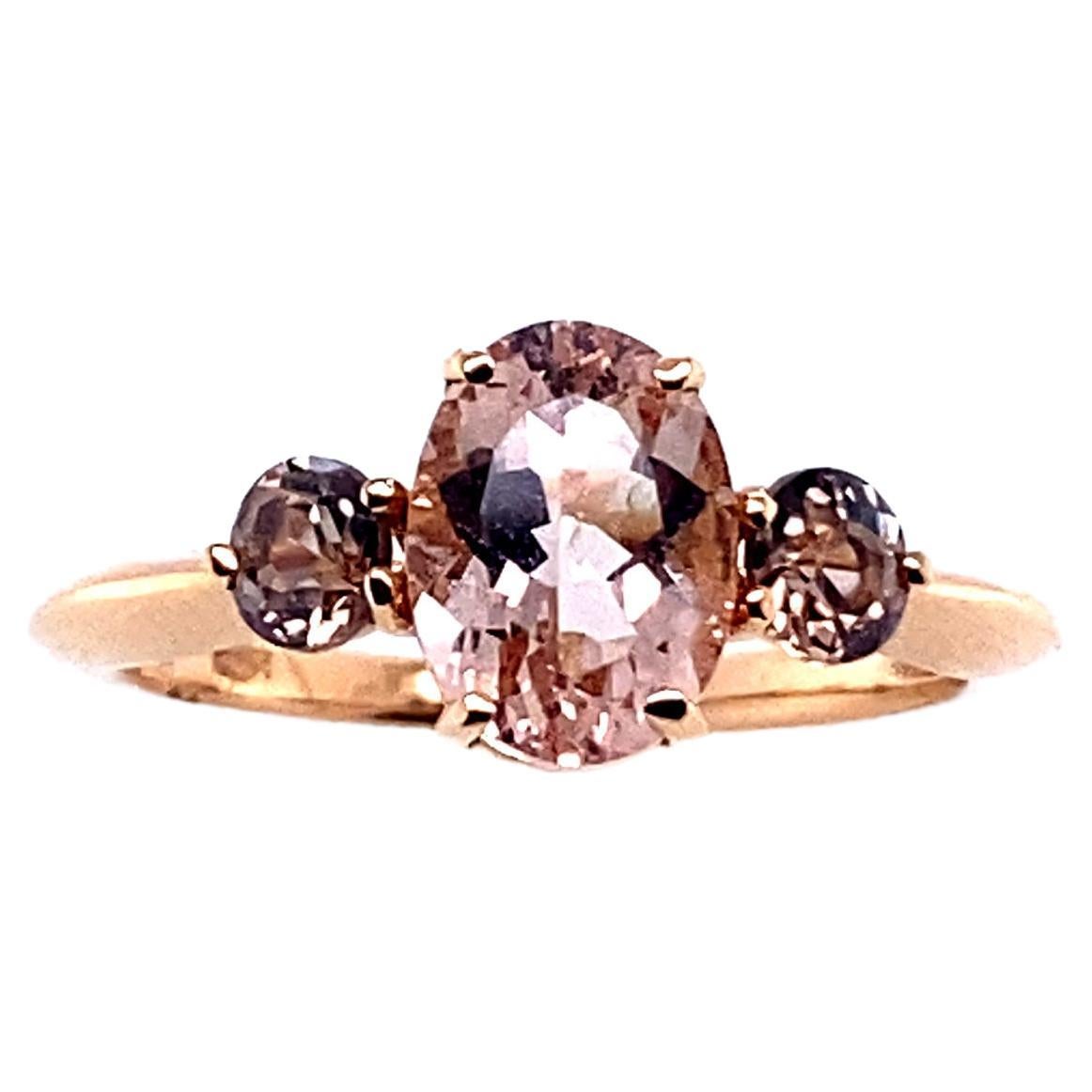 Rose Gold Ring Surmounted by a Morganite and Surrounded by Two Tourmalines

The weight of the gold is 2.60 grams of carats.
The weight of the ring is 2.9 grams.
The Morganite is 0.8 cm in length and 0.6 cm in width
The Tourmaline is 0.3 cm in length