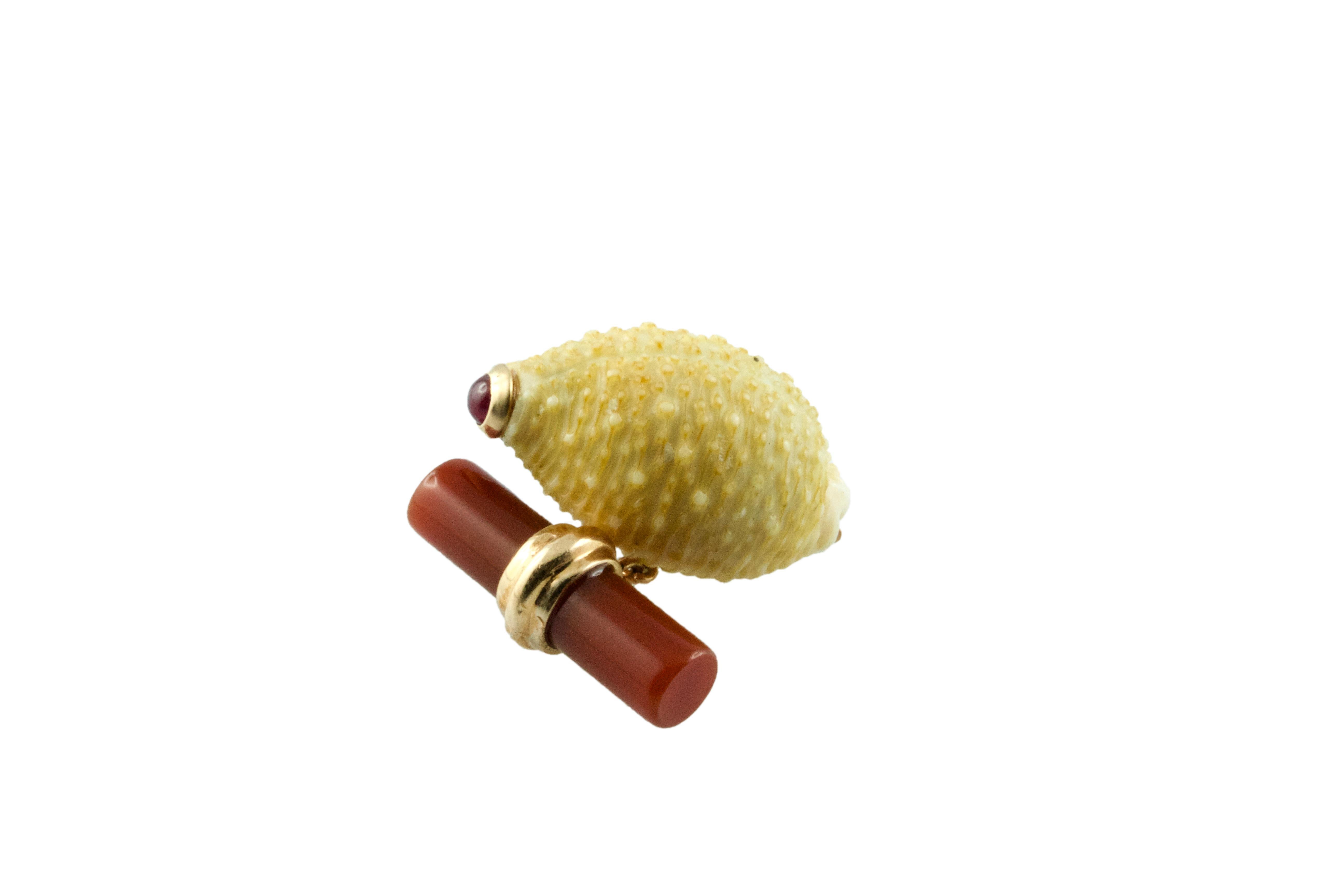 The striking natural patterns of the shell are the centerpiece of these cufflinks that are unique and elegant. Each shell is decorated with a cabochon ruby at the top, mounted in 14k rose gold, which also makes the post. The toggle is a cylinder