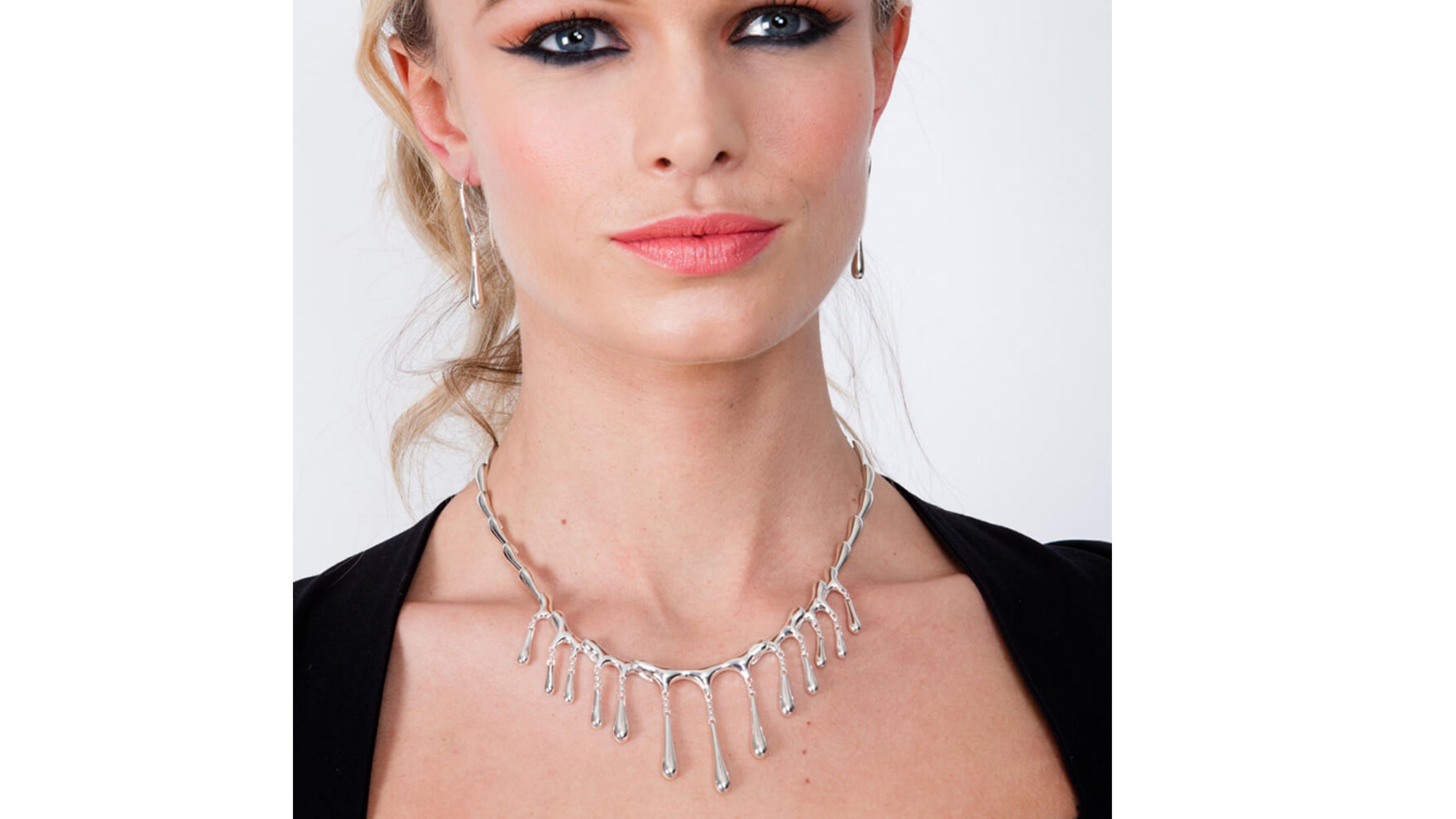 

Create a sense of drama with this iconic Short Multi Drop Necklace. The solid silver droplets give the impression of molten silver cascading down the neck and chest. Amazing to wear and much admired. This stunning design also won ‘Best Necklace in