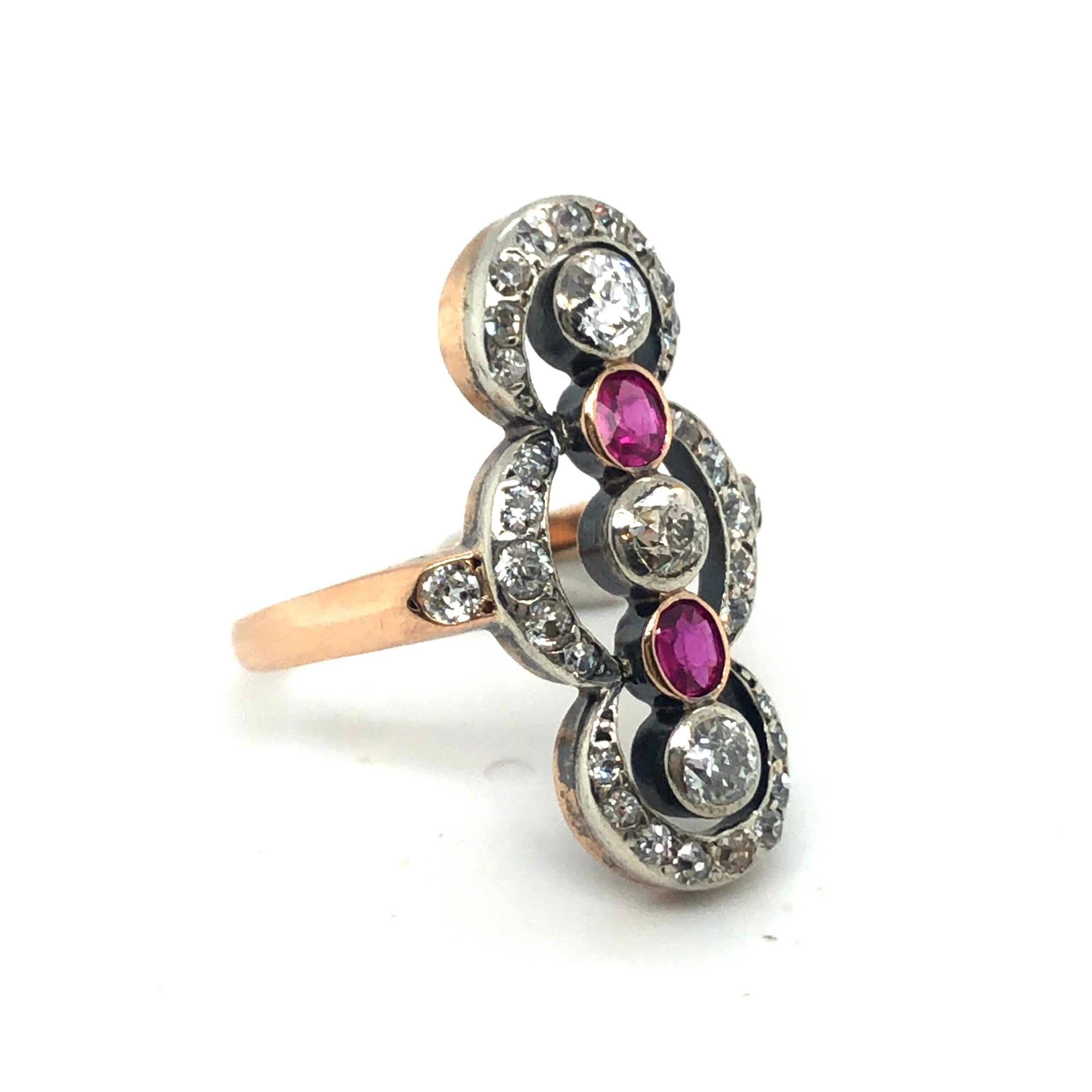 Charmy rose gold, silver, ruby and diamond antique dress ring, circa 1890.
Crafted in delicate openwork technique in 14 karat rose gold with silver overlay, this lovely ring is set with 2 pinkish oval rubies totalling circa 0.4 carats and 33 old-cut