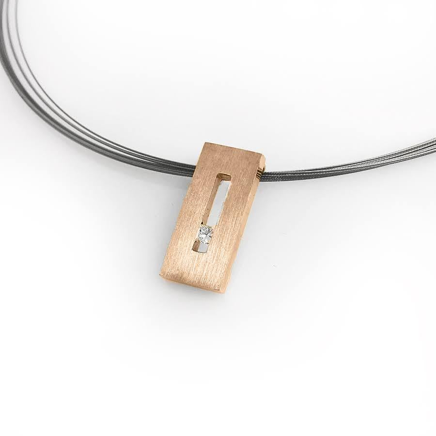 This Diamond in Rose Gold Suspended Rectangle Pendant is part of our Suspension Collection. Modern and architecturally inspired, this rectangle pendant is shown in rose gold with a brushed finish and set off center with an approximately .13pts