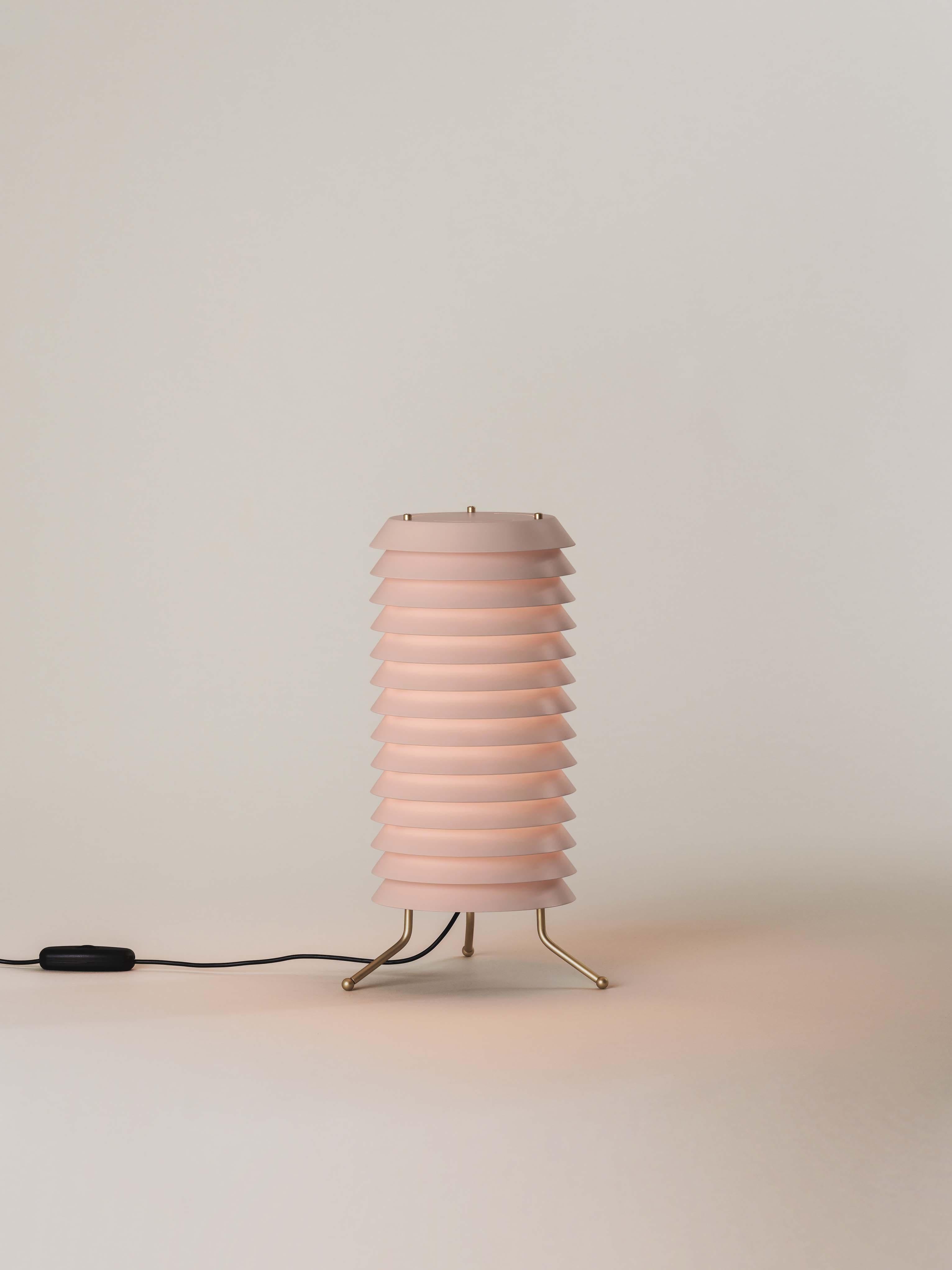 Rose Maija table lamp by Ilmari Tapiovaara
Dimensions: D 18 x H 33 cm
Materials: Brass, plastic.
Available in white or nude rose.

Maija conveys the feeling of light typical of Baltic cities, where the streets are barely illuminated, apart from