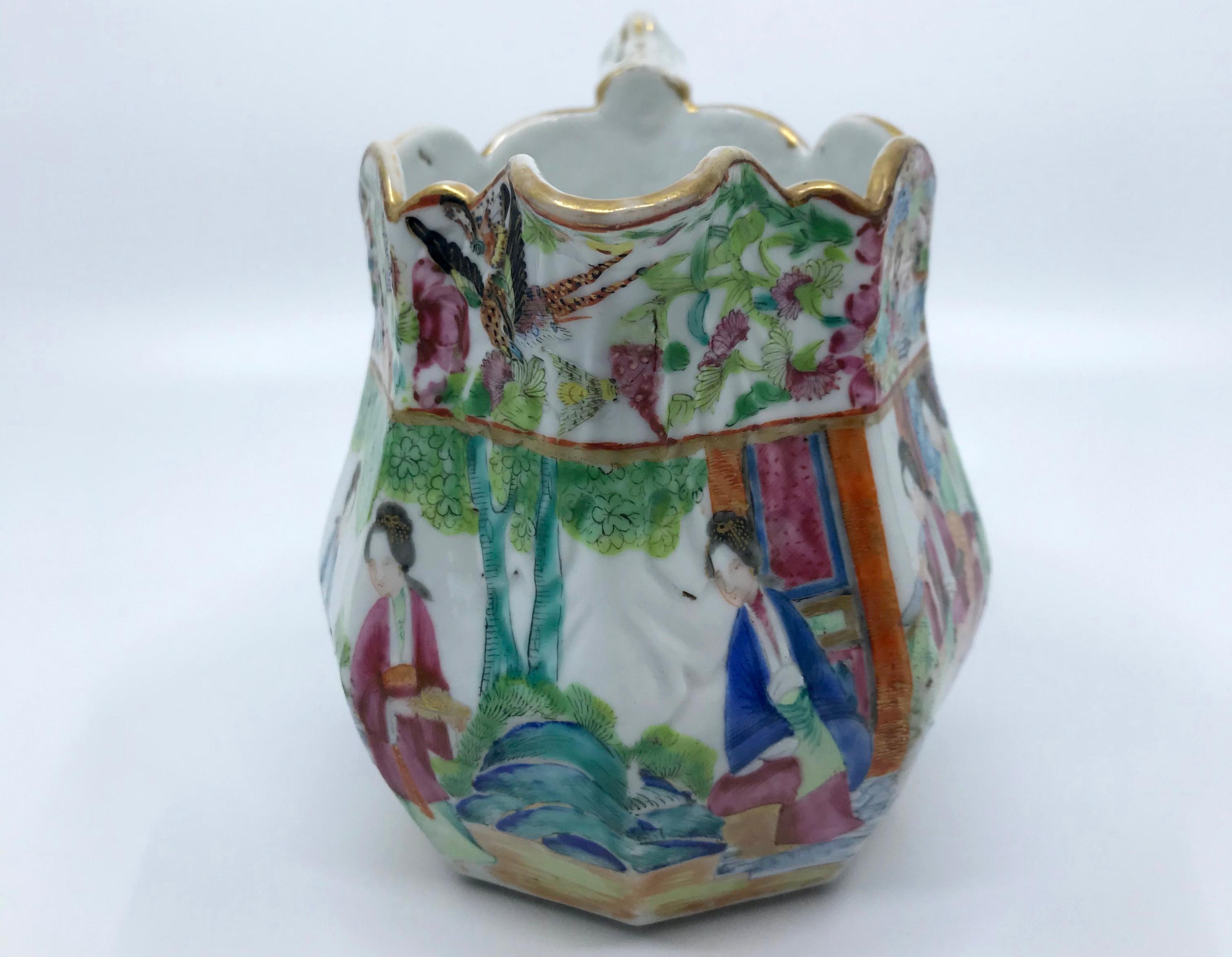 Rose Mandarin Chinese porcelain pitcher. Vibrantly hued and gilt painted Chinese Export pitcher in pinks and blues and greens with lobed rim and articulated handle. China, mid 19th century. 
Dimensions: 6.25