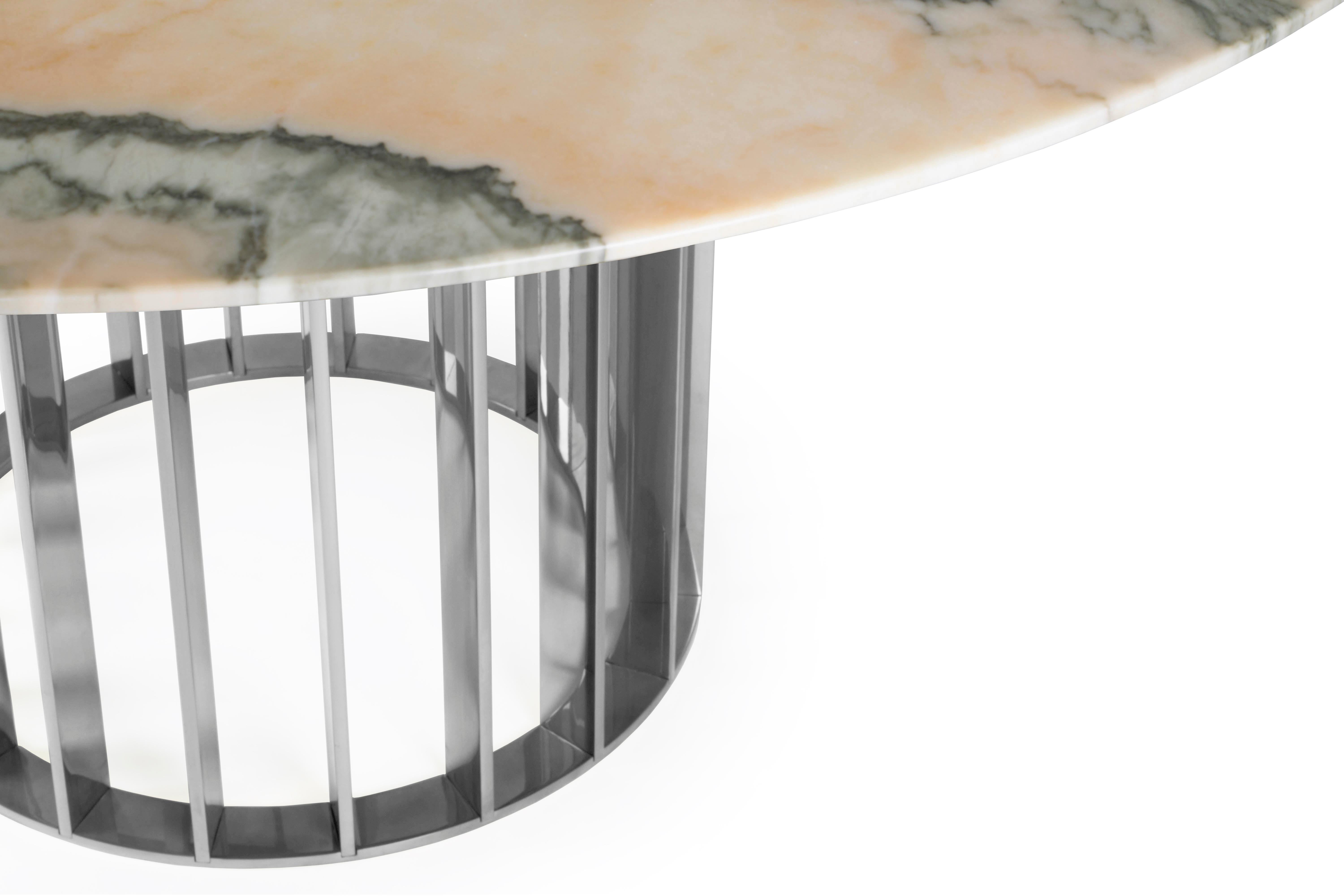 This unique dining table uses gorgeous rose marble top and elegant and modern stainless steel base uses the repetition of metal stripes to bring rhythm to the base. Its design is simple but full of grace and WOW factor. 
The best craftsmanship was