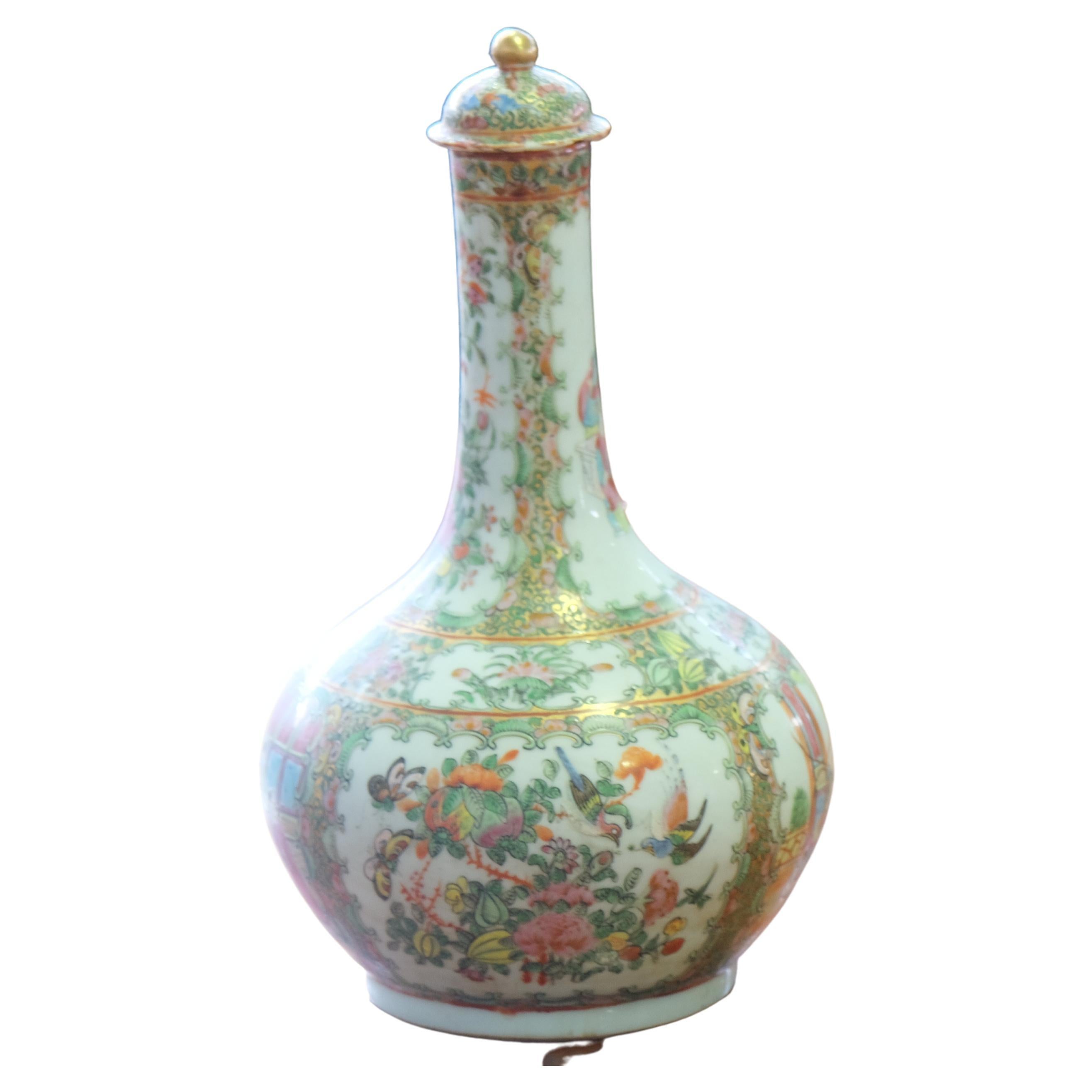 A beautiful Chinese Rose Medallion porcelain lidded water bottle with figural courtyard vignette decoration and butterfly, bird, insect and floral vignette decoration. Perfect from home design and decoration.