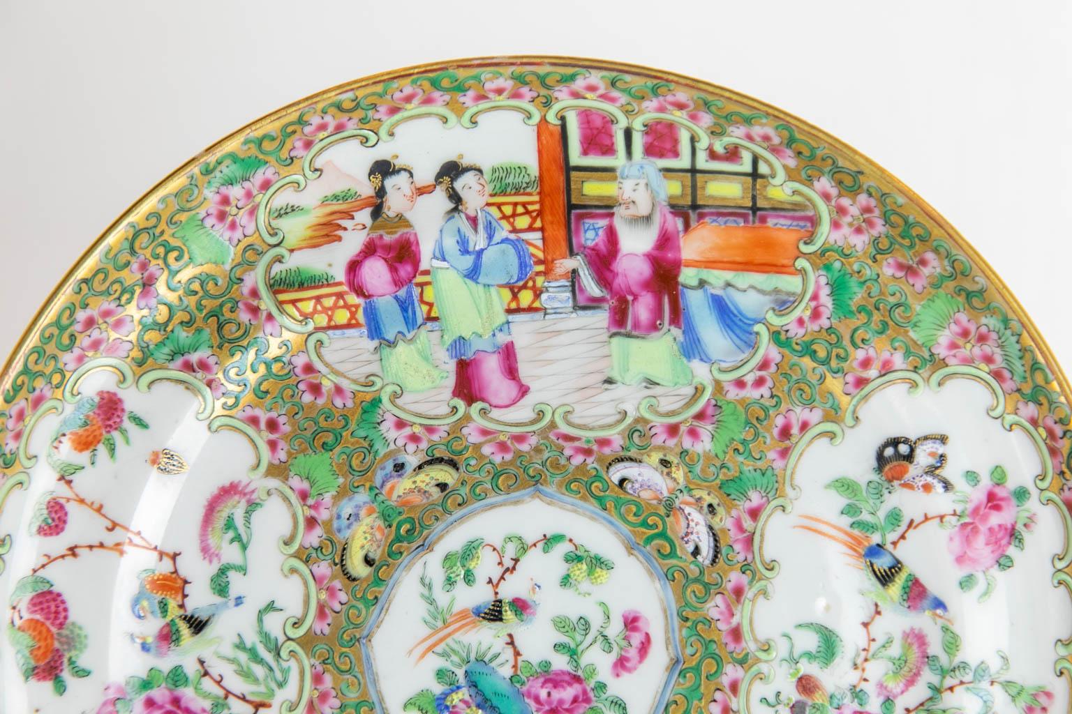 This Chinese plate is in mint condition. There are four cartouches depicting Mandarin figures, birds, butterflies, fruit, and flowers.