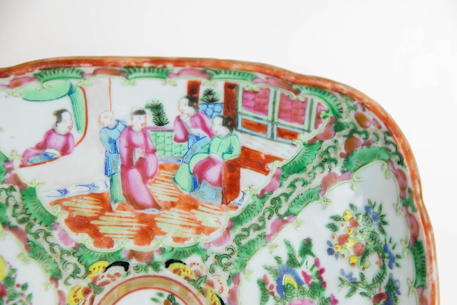 This Chinese dish is in mint condition. There are four cartouches depicting Mandarin figures, birds, fruit, and flowers.