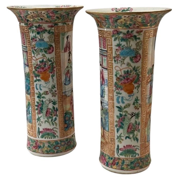 A fabulous pair of 19th century rose medallion trumpet vases with courting scenes.
