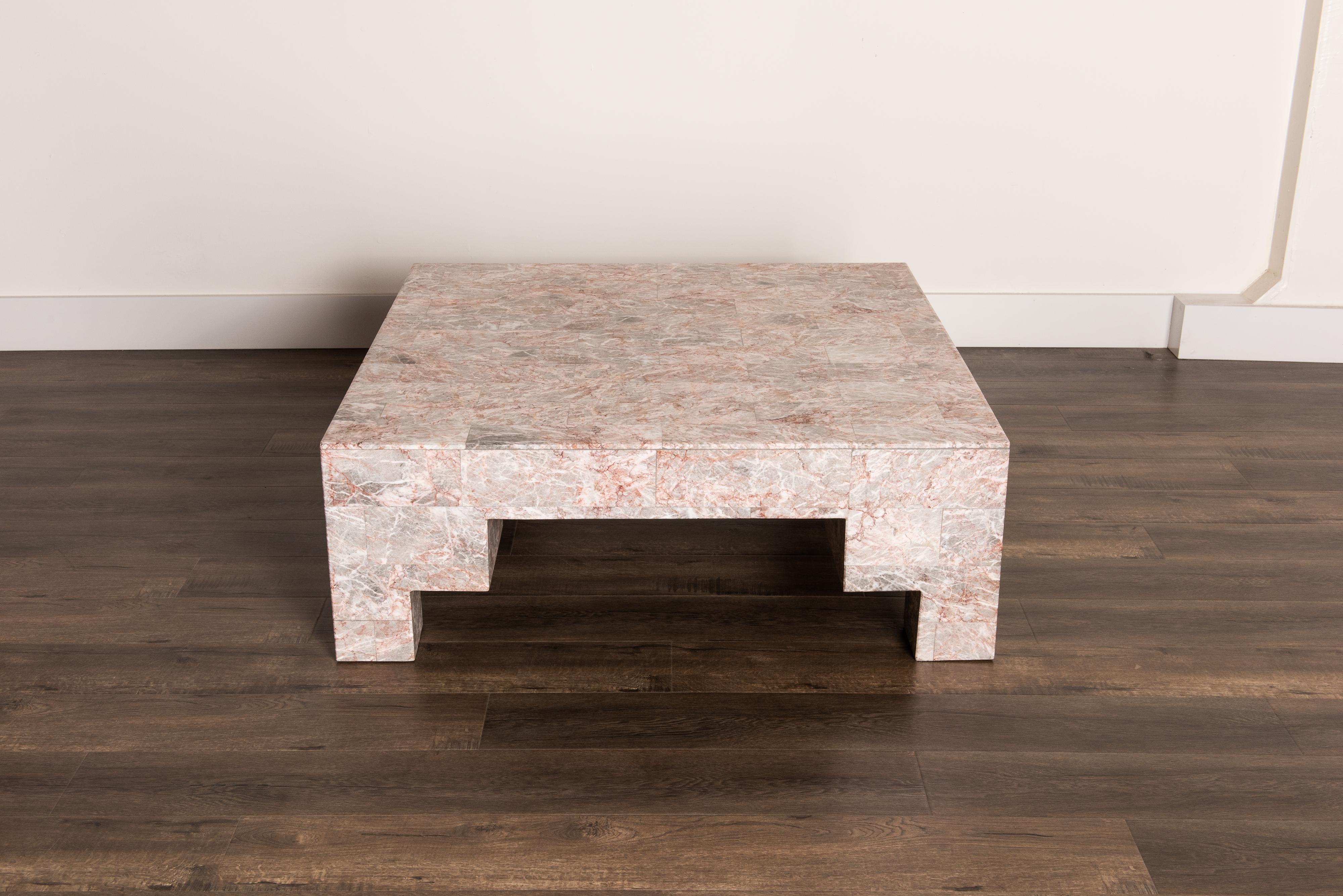 So gorgeous and designer on-trend, this heavy and substantial Post-Modern coffee table is constructed from rose pink and grey marble. The angled and architectural shape makes it perfect for a Postmodern room, while the beautiful marble stone veining