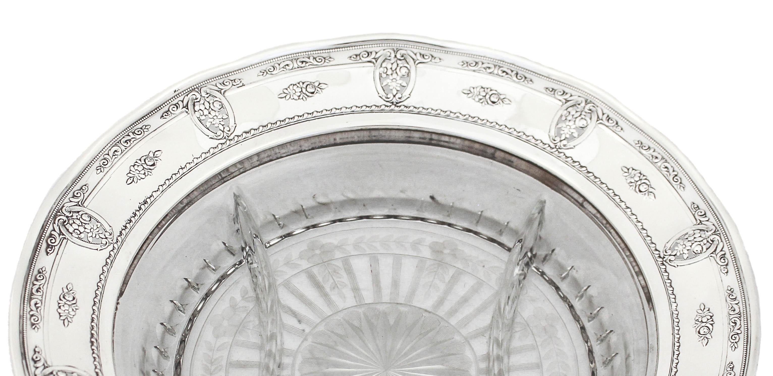 Being offered is a sterling silver and crystal sectional in the Rose Point pattern by Wallace Silversmiths.  The sterling rim is fluted with the Rose Point pattern adorning it. In the center the crystal sectional is divided into three parts; a