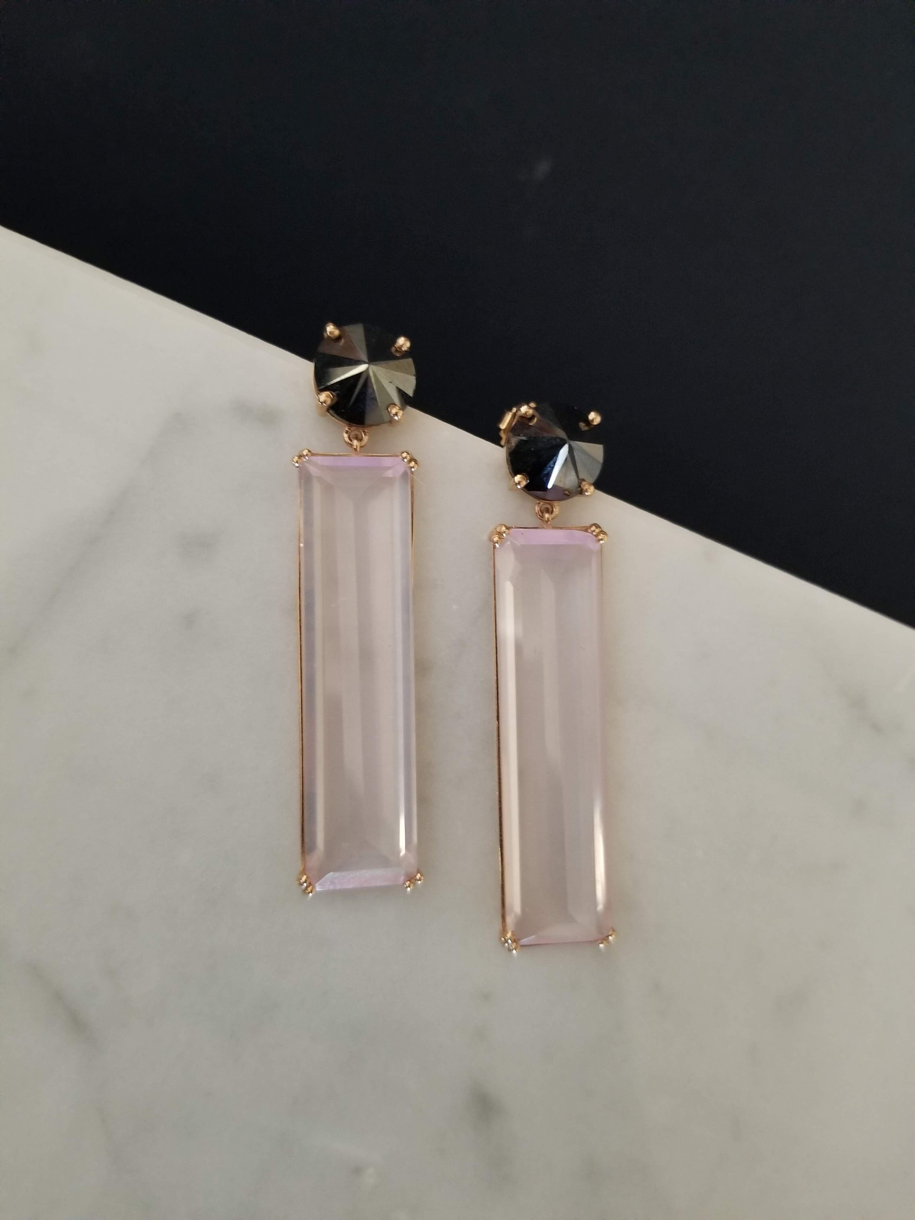 These beautiful earrings have 2 Rectangular Rose Quartz Gems Weighing 44.51cts and 2 Round Black Diamonds Weighing 9.98cts Set in Reverse!!! 

Everything is set in 14K Rose Gold and 2.25 inches long. 

Such a beautiful piece to add to your