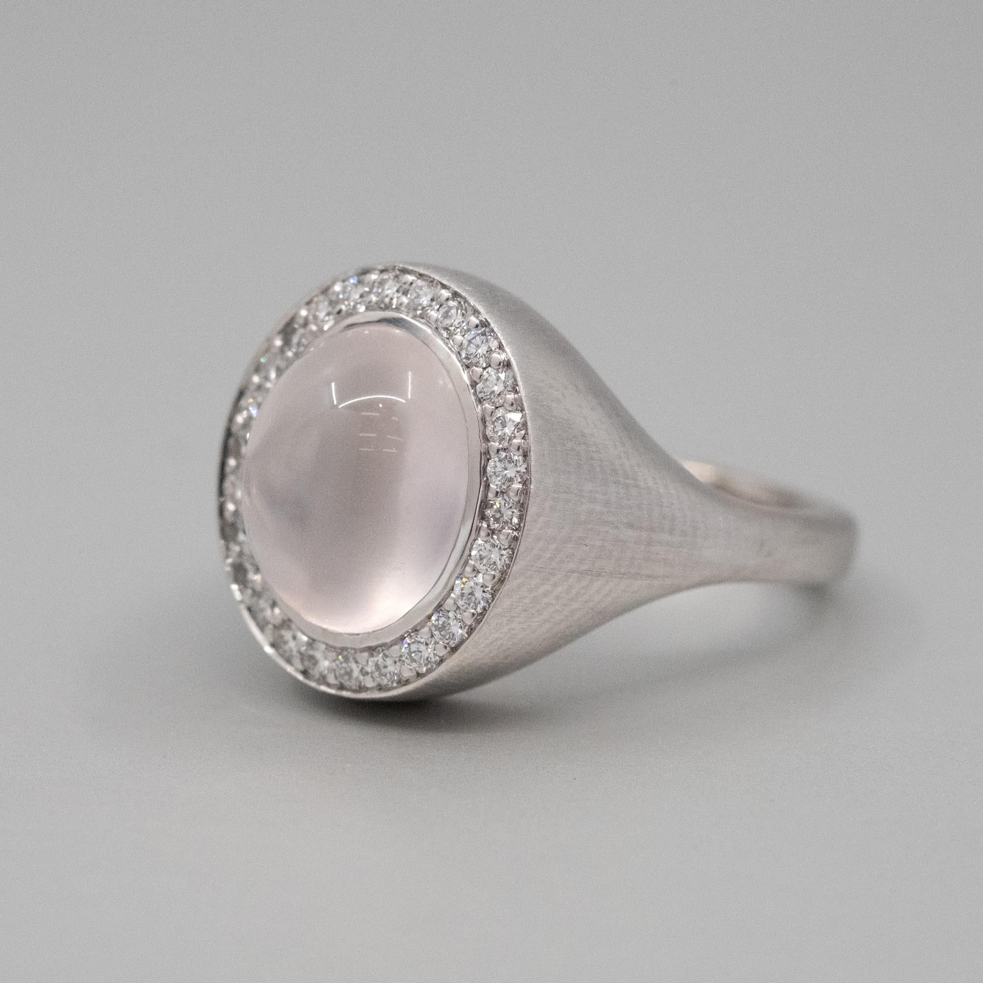 A BUNDA Corvus ring, set with a rose quartz in 18ct white brushed gold. Signed BUNDA.
Characteristics of Pink Cabochon cut Quartz; 1 = 4.87ct.
Characteristics of Round Brilliant Cut Diamonds: 26 = .29ct, F colour, VS Clarity
Total weight: 11.16