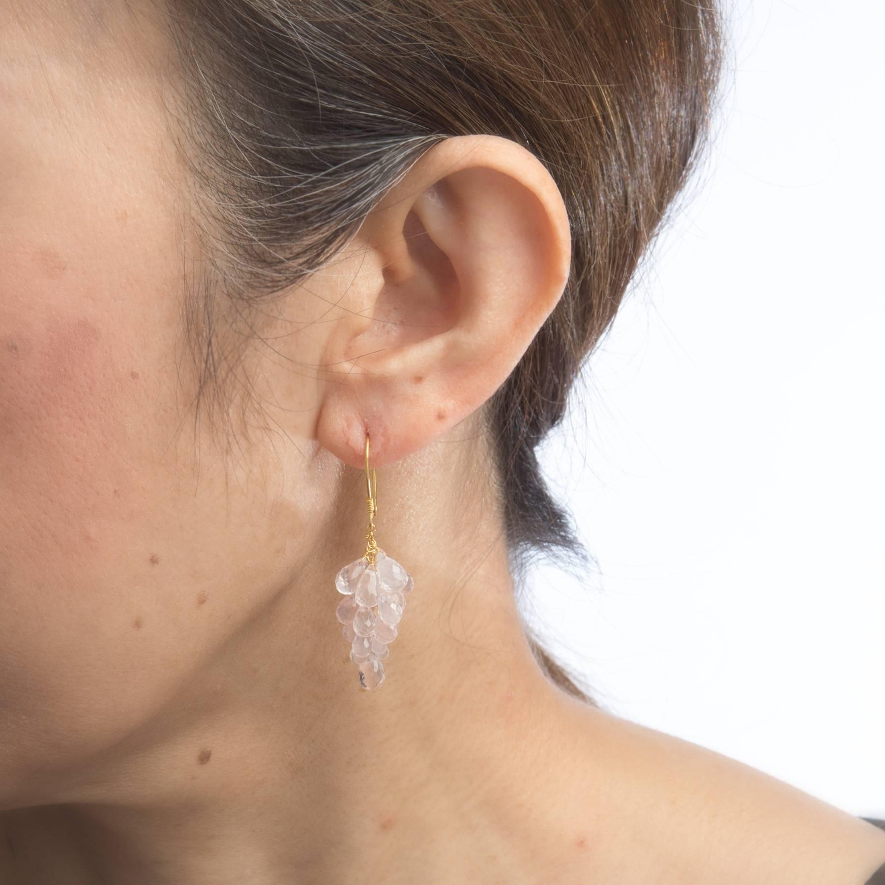 Overview:

Elegant pair of cluster drop earrings, crafted in 18k yellow gold. 

Briolette faceted rose quartz measures (average) 4mm to 5mm. The rose quartz is in excellent condition and free of cracks or chips.   

The earrings feature fish wire