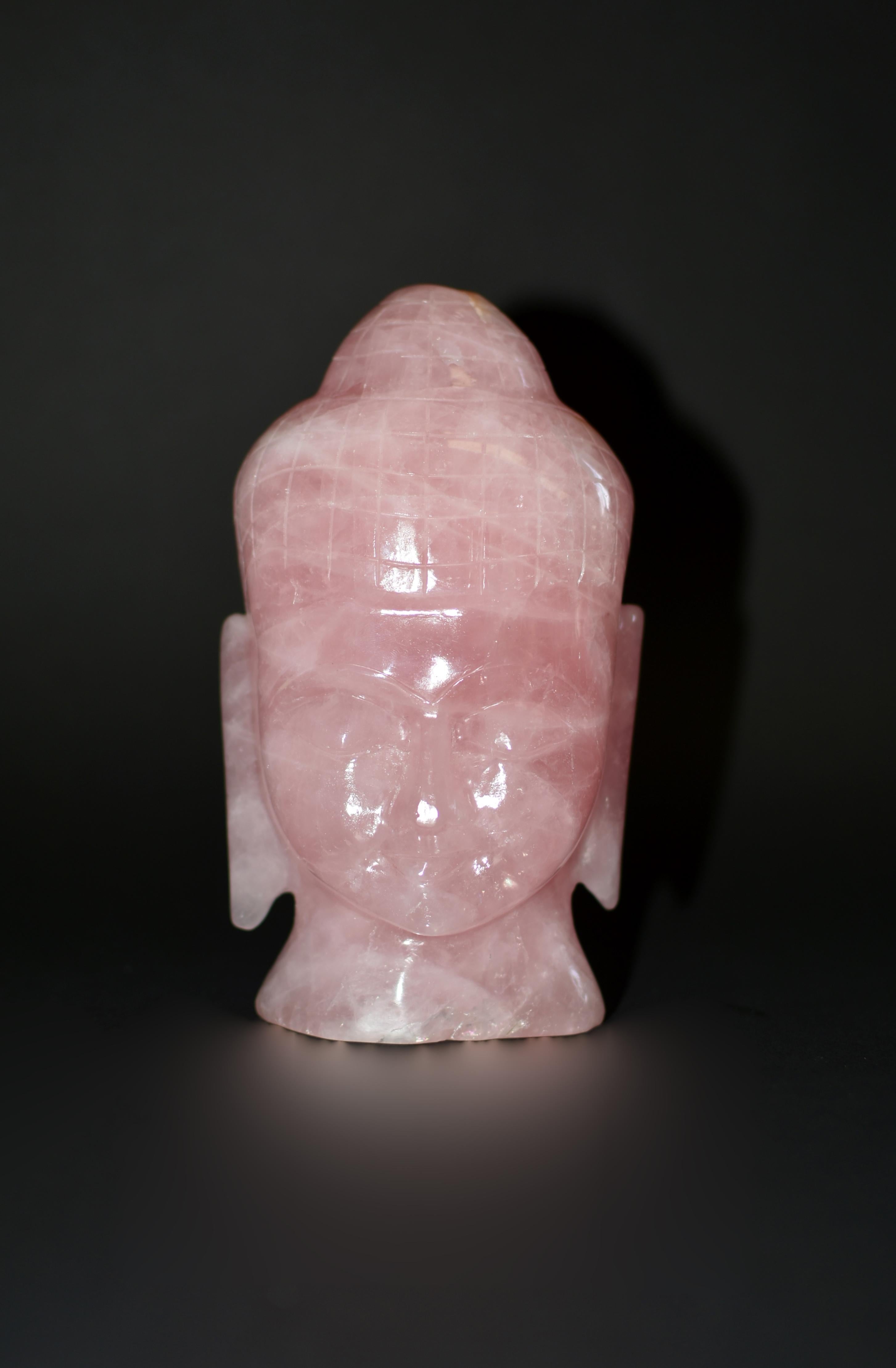 100% natural finest AAA grade rose quartz. Statue is hand carved of a young Shakyamuni with downcast eyes above pursed lips, flanked by long earlobes, all under hair neatly mounted on top of his head. The fine quality of the gemstone allows the