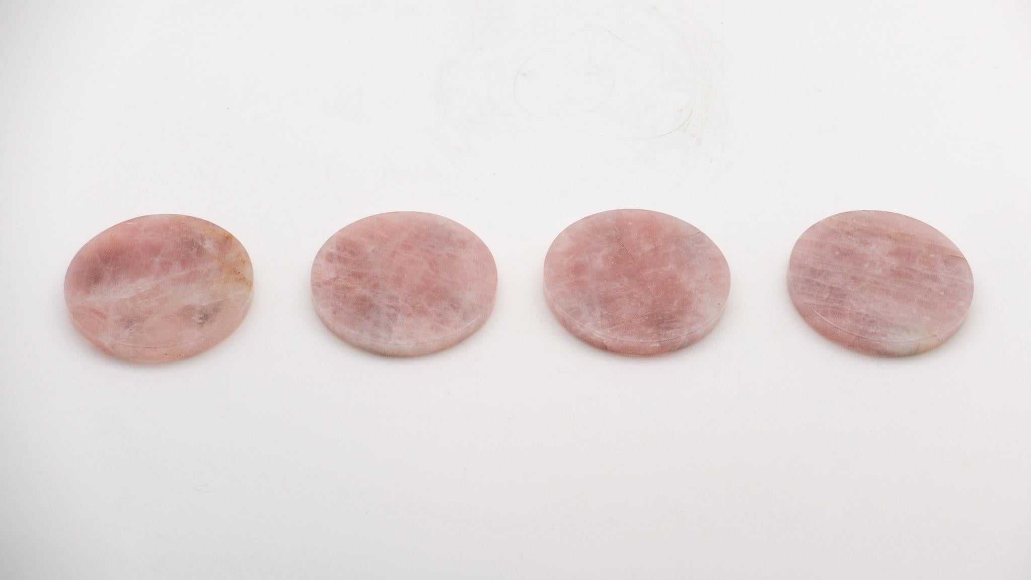 Set of four rose quartz beverage coasters. Rose quartz is a variety of quartz immediately recognizable among other quartz varieties by its soft pink hue.