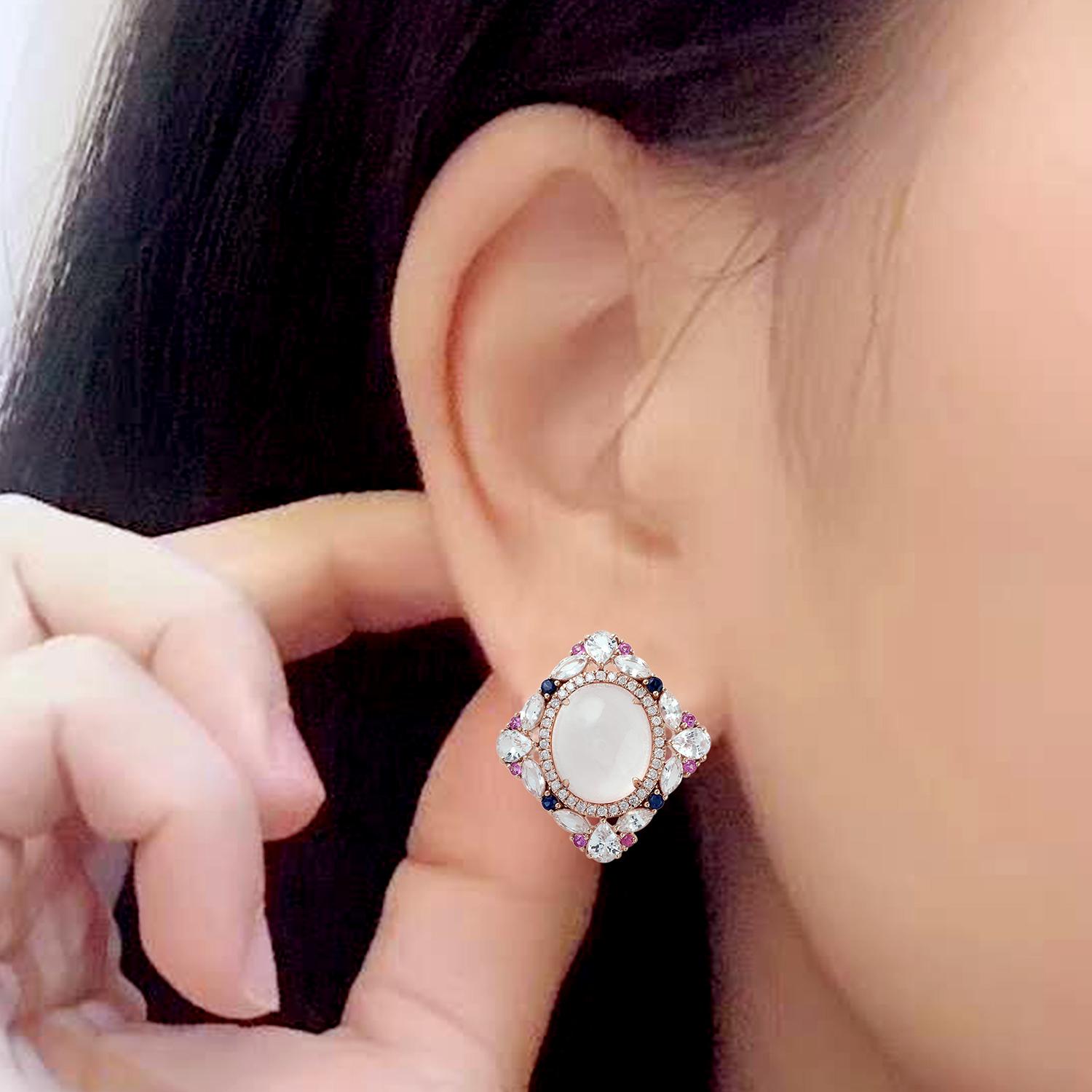 This beautiful stud earrings are cast in 18-karat gold. It is hand set in 10.14 carats rose quartz, 3.74 carats blue sapphire and illuminated with .33 carats of glittering diamonds. 

The ring is a size 7 and may be resized to larger or smaller upon