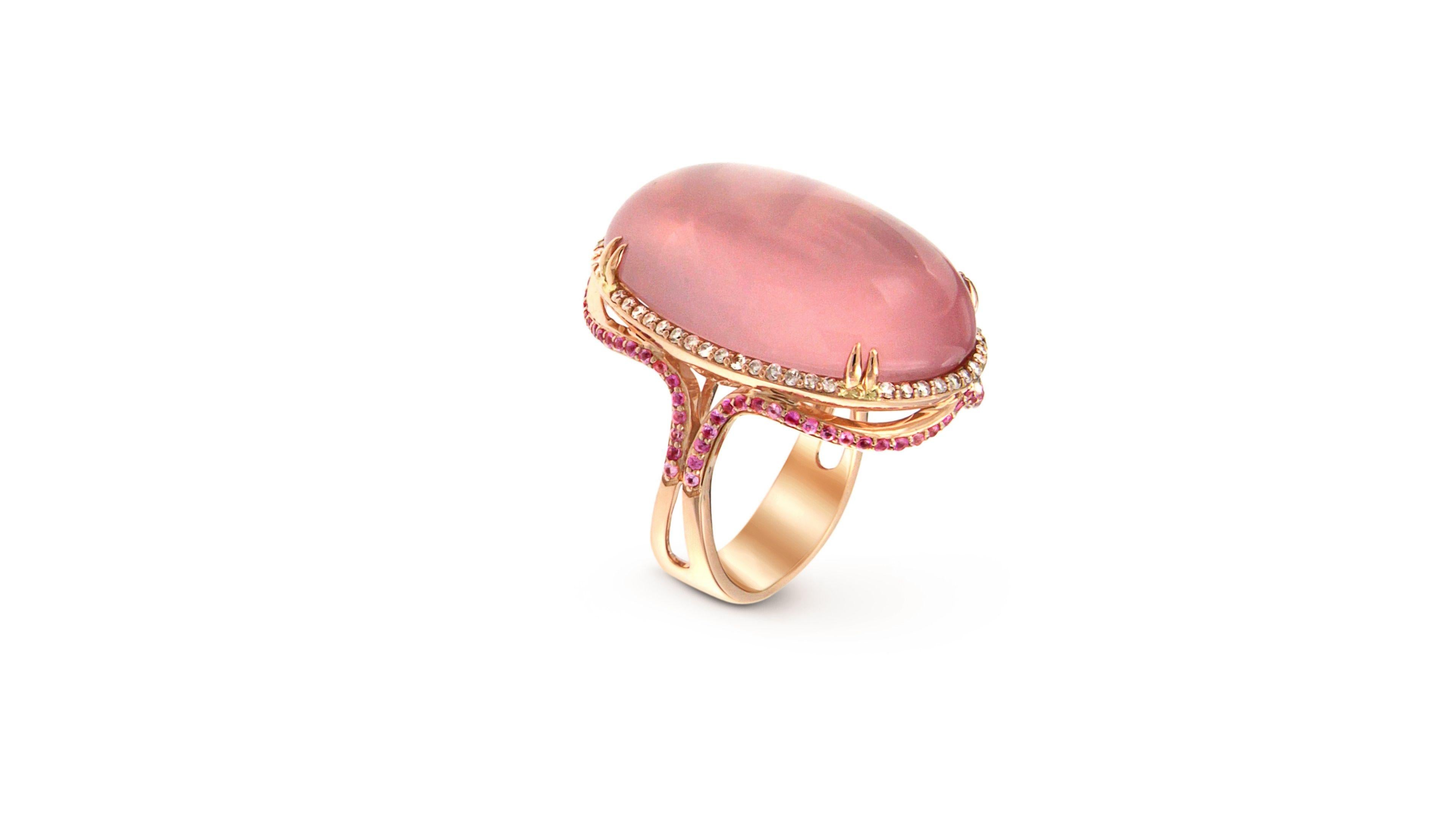 This is a unique Rose Quartz ring set in 18k Rose Gold with around 70  Diamonds and also 56  pink Sapphires.  Has a very elegant look and stands out.

Let us know your size