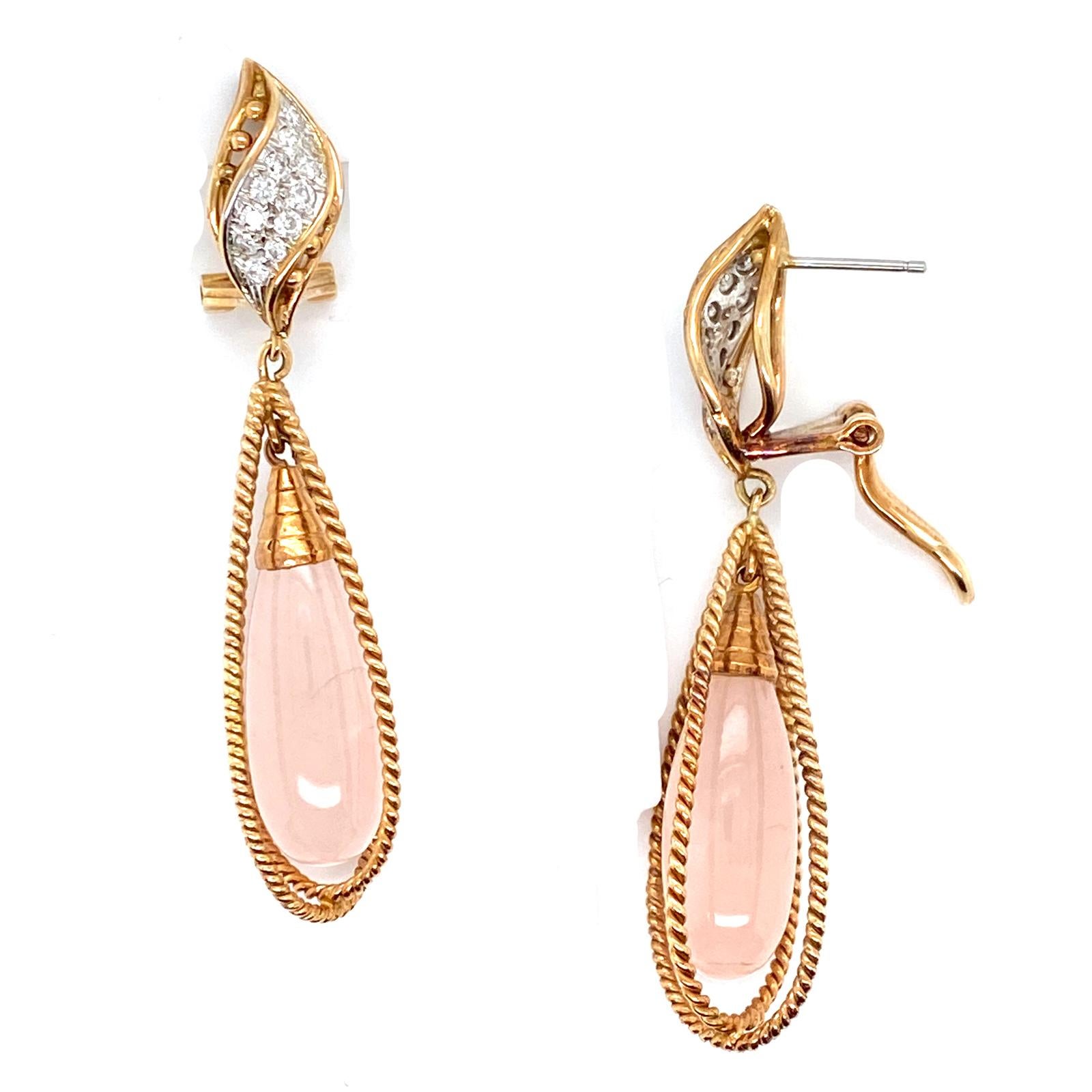 Beautiful pink quartz diamond drop earrings fashioned in 14 karat yellow gold. The 24 round brilliant cut diamonds weigh .50 carat total weight and are graded G-H color and SI clarity. The rose quartz drops are caged between textured/twisted yellow