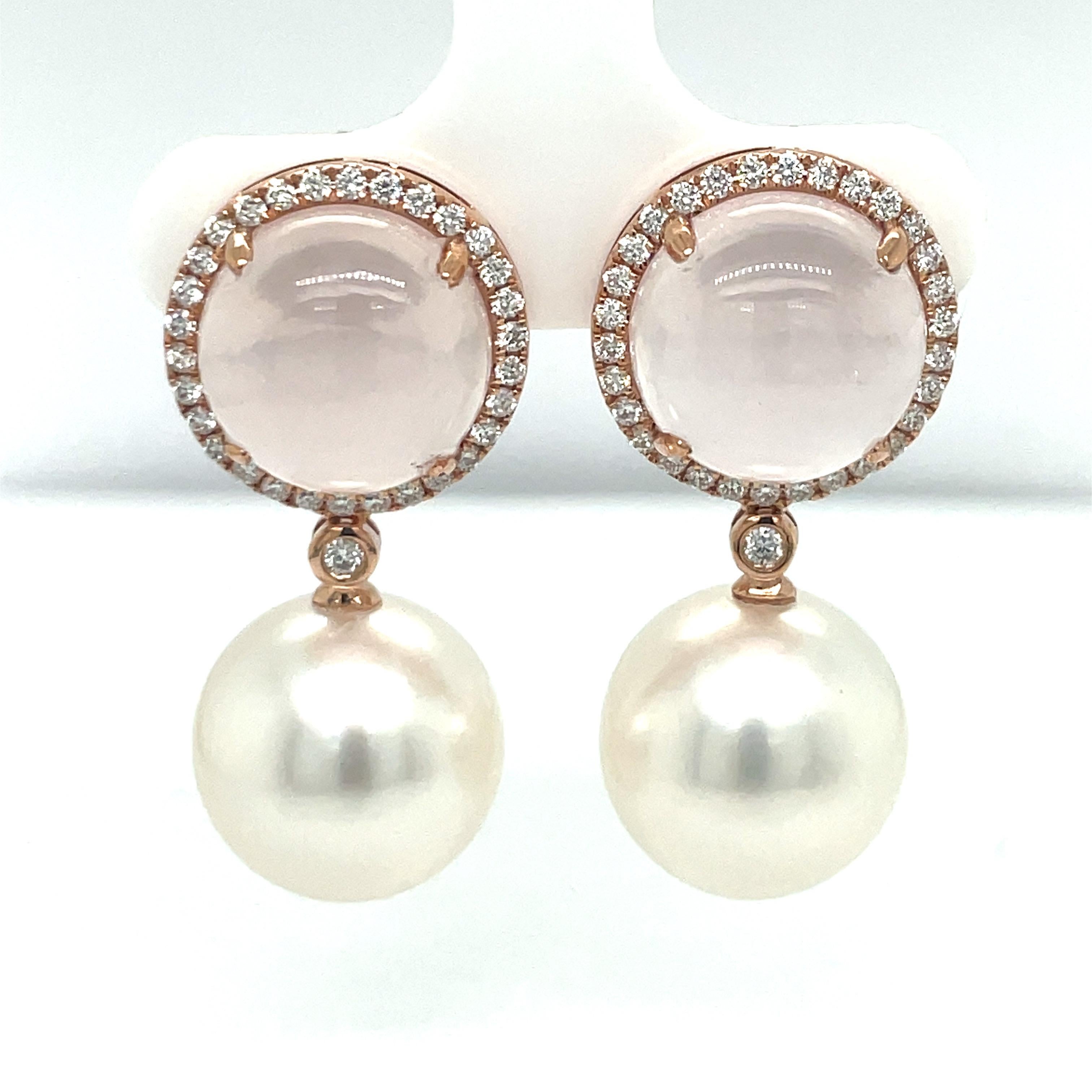 18 Karat Rose Gold drop earrings featuring two round Rose Quartz weighing 11.69 Carats surrounded by 62 round brilliants weighing 0.51 Carats and two South Sea Pearls measuring 13-14 MM.
Can customize Pearl color. 