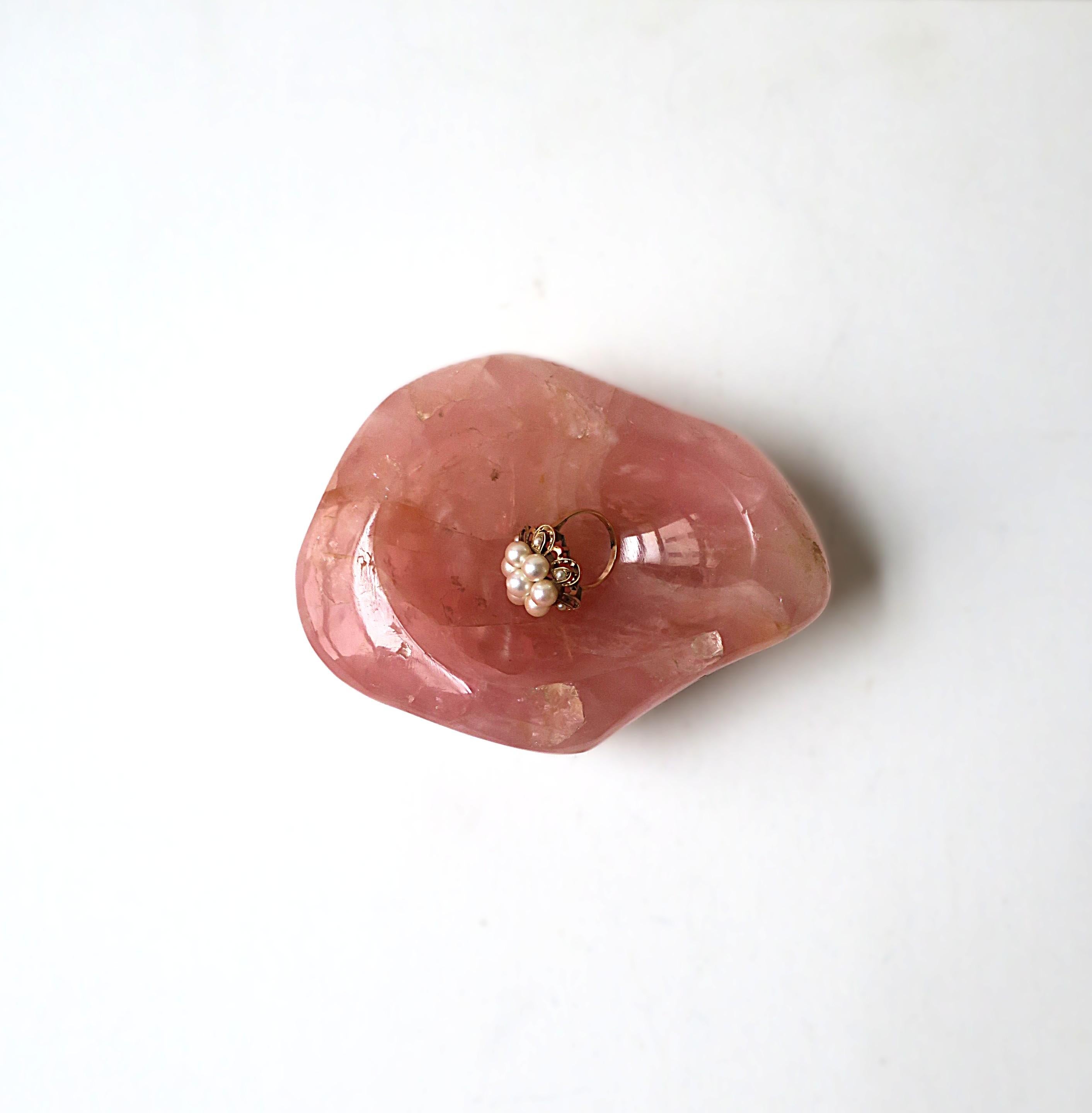 A substantial natural pink rose quartz jewelry dish in an organic shape, polished smooth, circa mid-20th century. Piece has a beautiful pink hue with an organic shape and a polished bowl and edge surface. A great piece for a vanity, dresser,