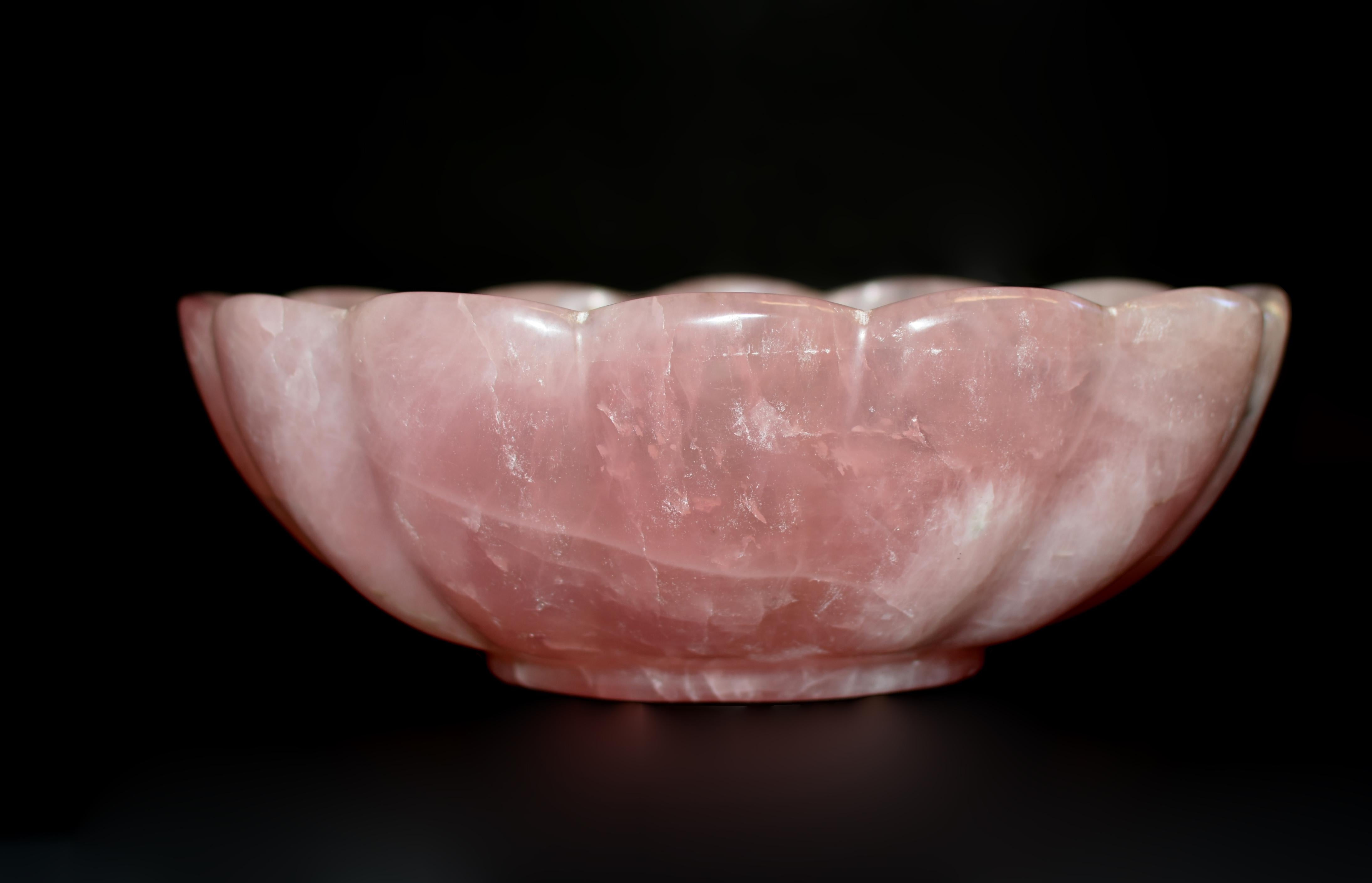 This exceptionally large, hand-crafted bowl is a stunning work of art, carved from a single massive piece of Madagascar's finest rose quartz. In elongated oval shape on a solid foot, with scalloped edges and ribbed 