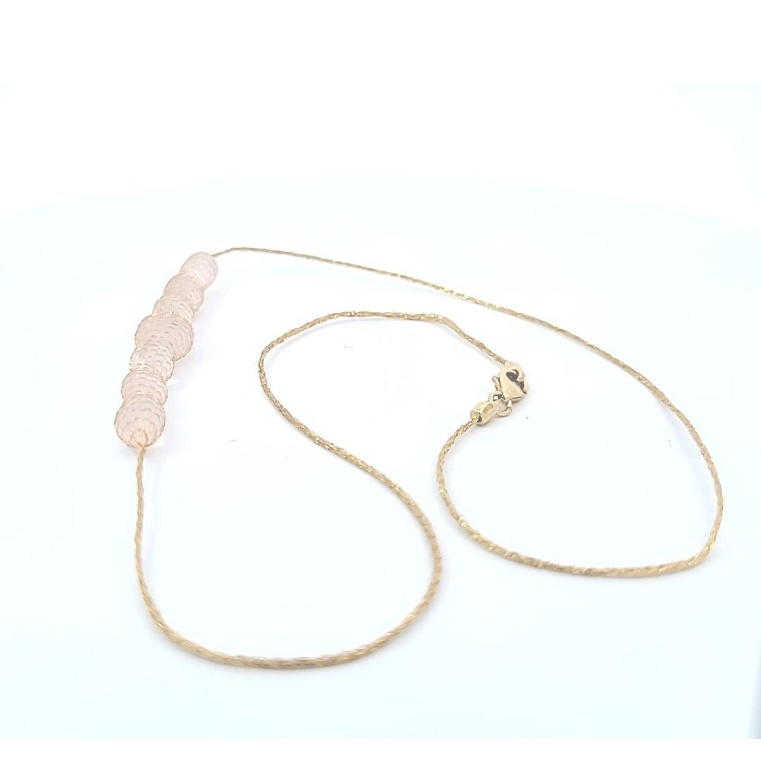 Such an unusual look!  Rose quartz beads enclosed in netting.