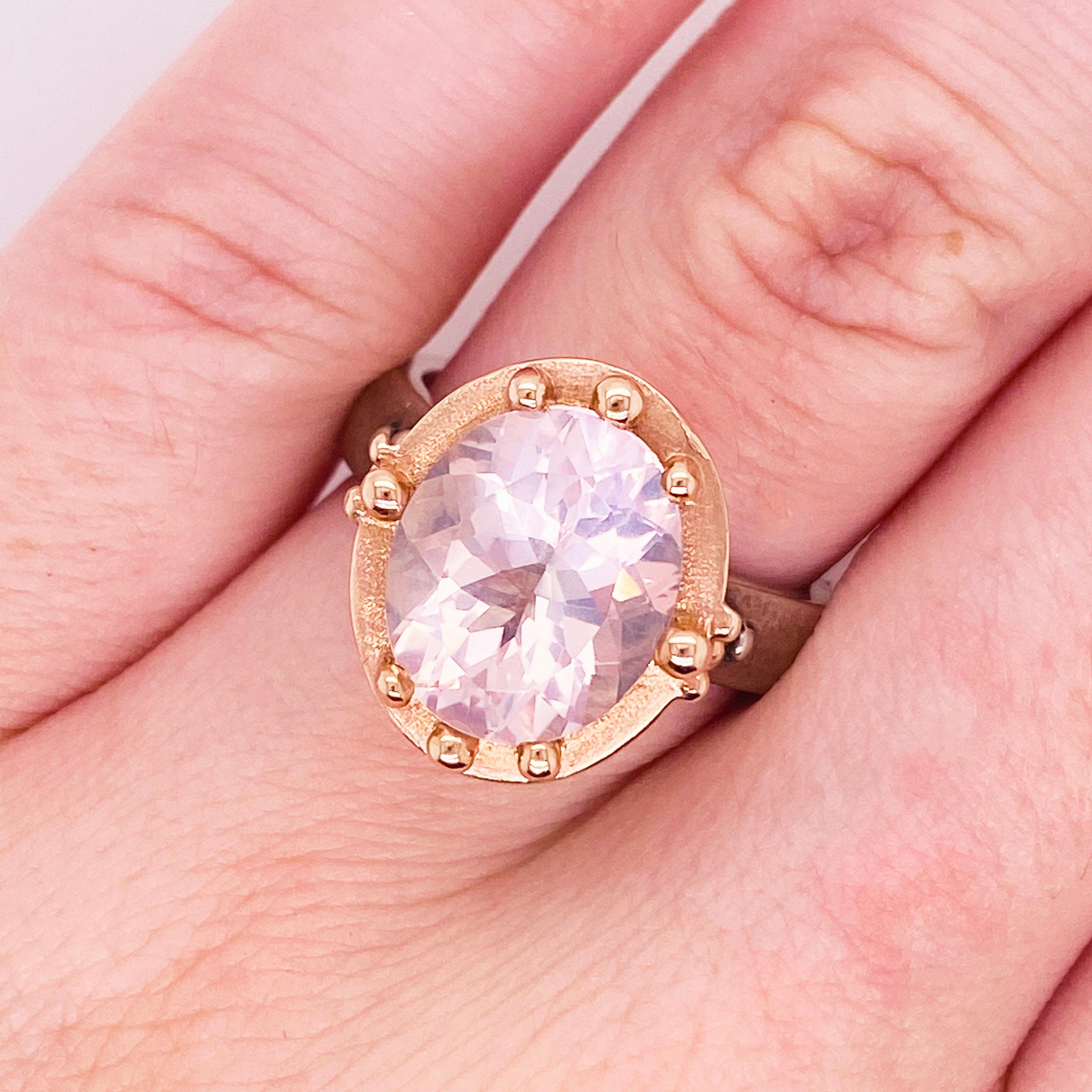 This stunningly beautiful pink oval rose quartz is set in 14 karat rose gold with a sterling silver band will thrill you! The style is both modern and classic with the matte textures combined with bright round metal accents at the same time! This