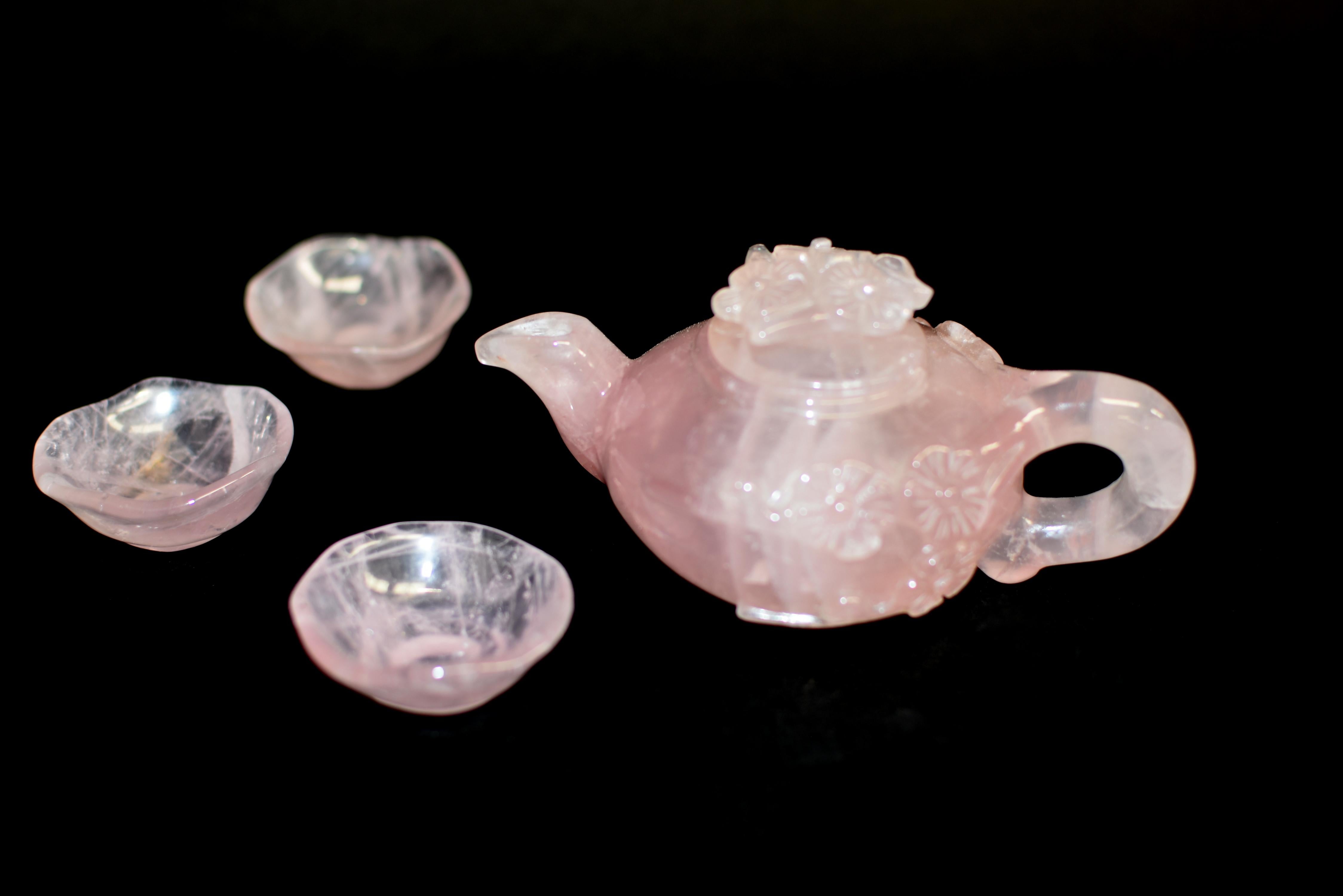 Absolutely beautiful all natural finest grade rose quartz tea pot and cups. The exquisitely hand carved pot has rounded sides rising to the top before being capped off by a fitted lid, flanked by a short curved spout and c-shaped handle, rising on a