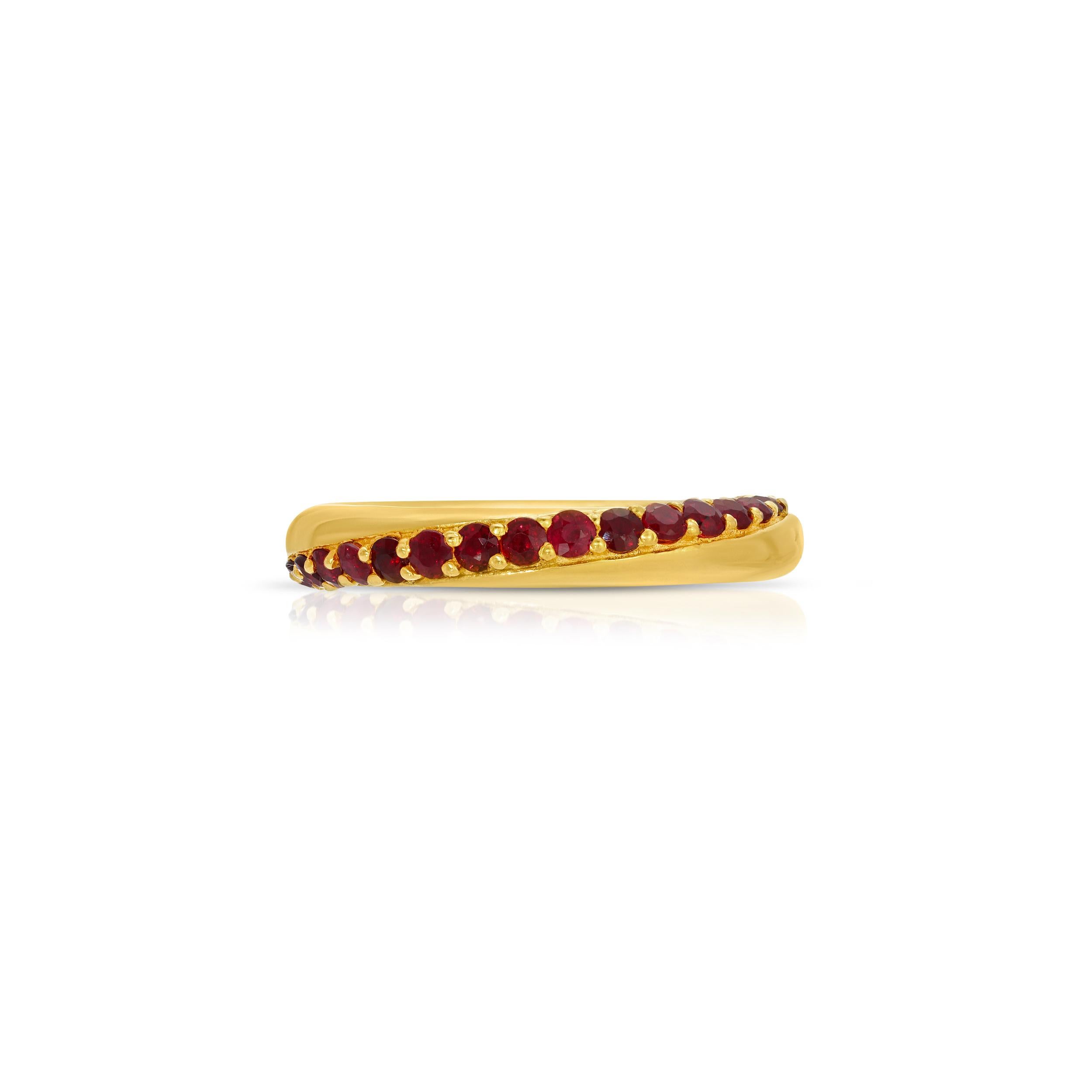 A rounded gold band of contemporary design featuring stunning gemstones. This ring features 2.42 Carats of fiery red Rubies set in a modern swirl design. This ring is set in 22 Karat Gold overlay Silver.