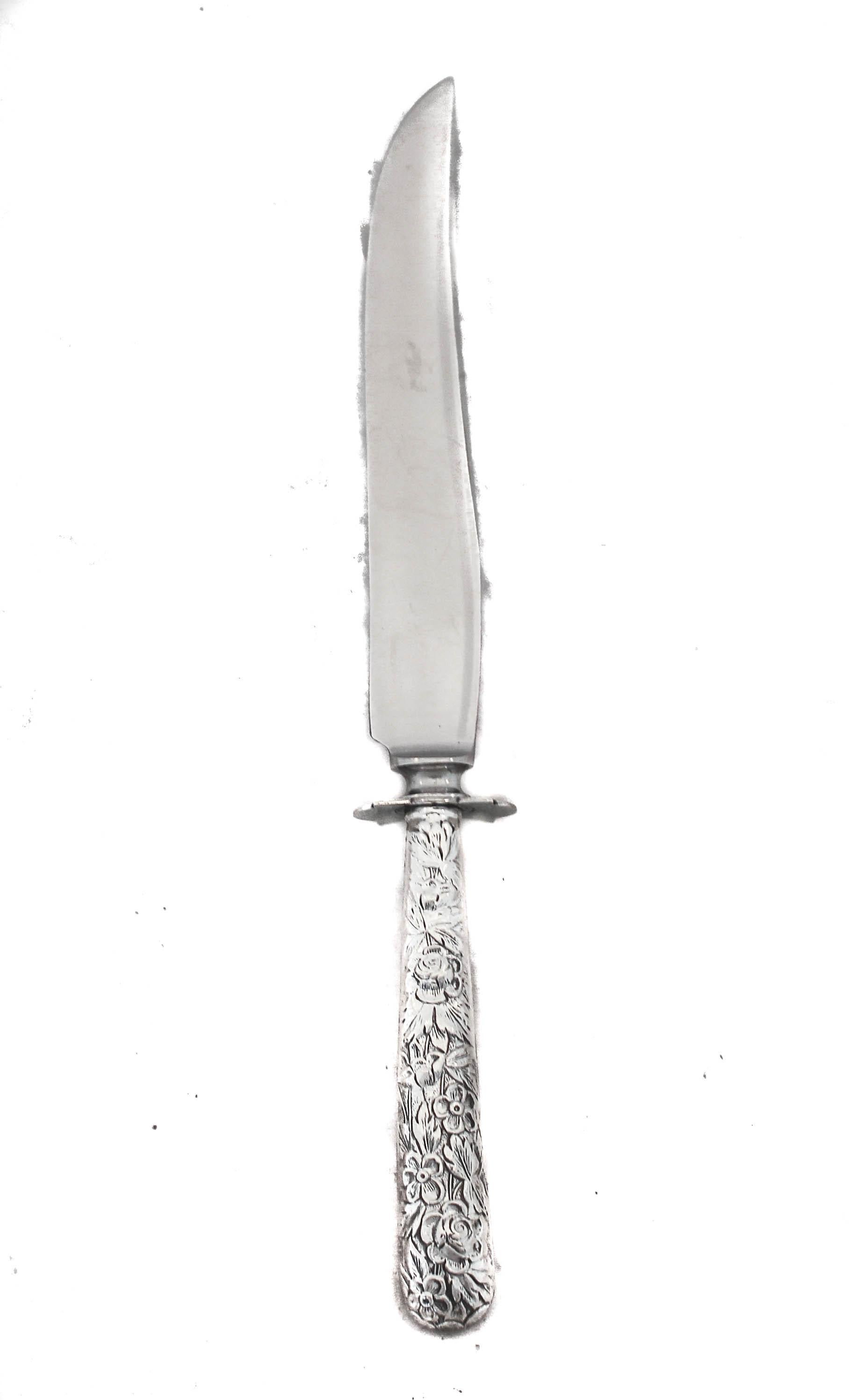 We are happy to offer you this sterling silver carving fork and knife in the Rose pattern by Kirk-Stieff Silver Company. Blown-out flowers and leaves decorate the handles in the classic Rose pattern that became so popular and synonymous with the