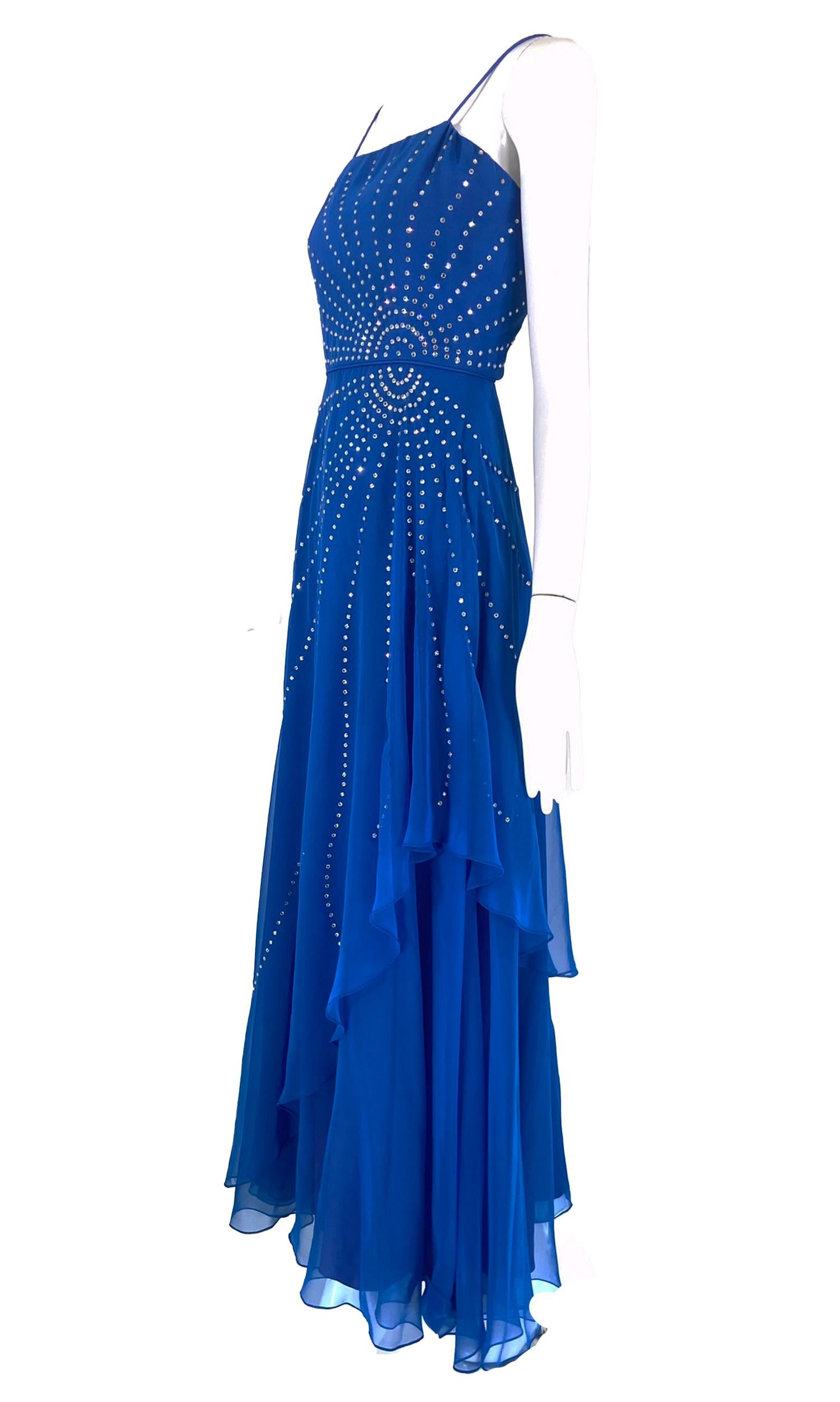 Rose Taft Couture Fashions royal blue chiffon rhinestone sunburst evening gown from the 1970s. Fitted bodice gown with spaghetti straps has a 1940s feel, prong set crystal rhinestones are set in a circular design with rays that sparkle across the