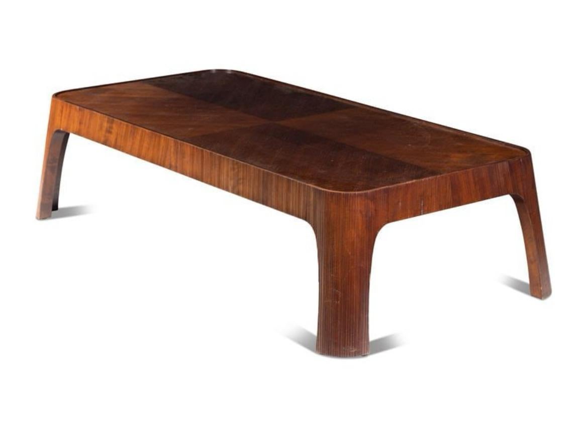 Rose Tarlow Reeded Bois walnut coffee table.
Coffee table featuring reeded base of four splayed legs with quartered top. 

H 18 x W 72 x D 36 inches.