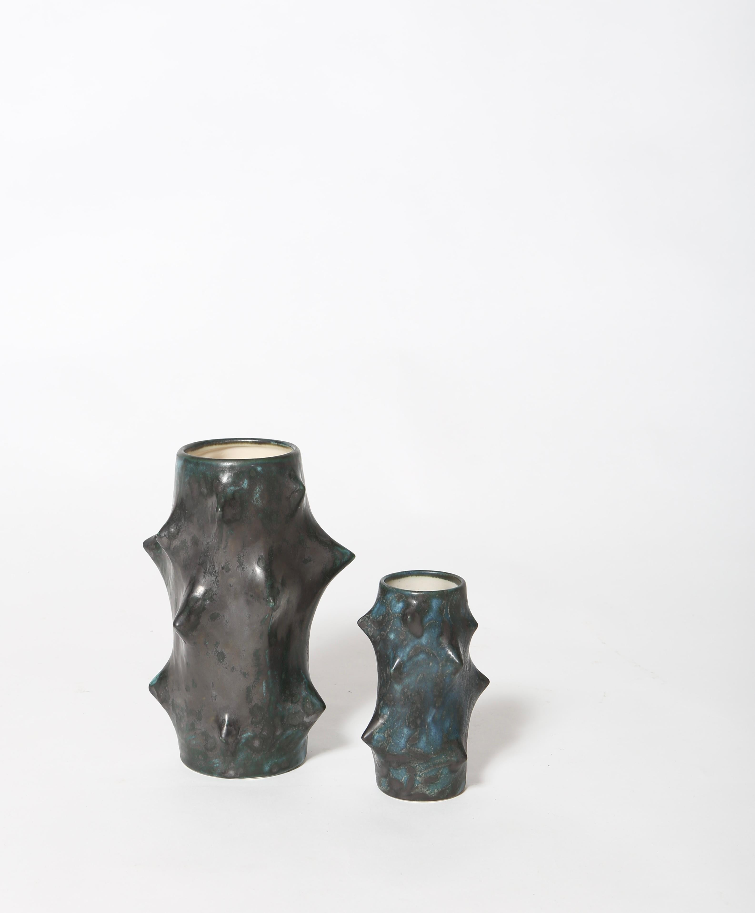 Fantastic early production set of “Rose Thorn” vases by Knud Basse. Petroleum green glaze with subtle iridescent black over glaze and ivory interior. Excellent condition, signed on underside. Rare to find!