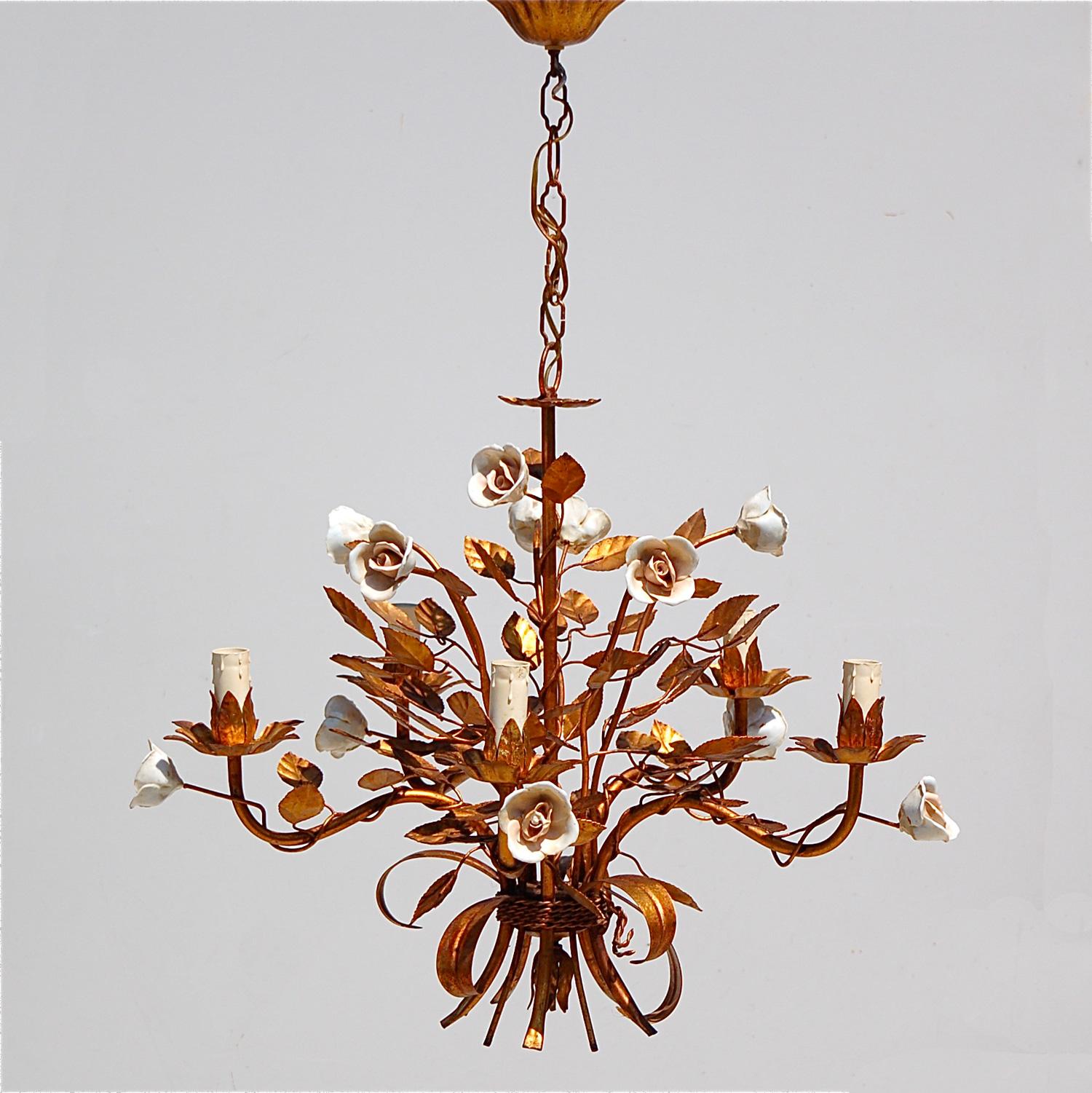 Alternative take on the Coco Chanel sheaf of wheat chandelier, this floral or rose tole pendant light is decorated with porcelain roses, leaves and has five arms with drip effect candle bulb holders. This gilt tole, ormelu, Florentine pendant light