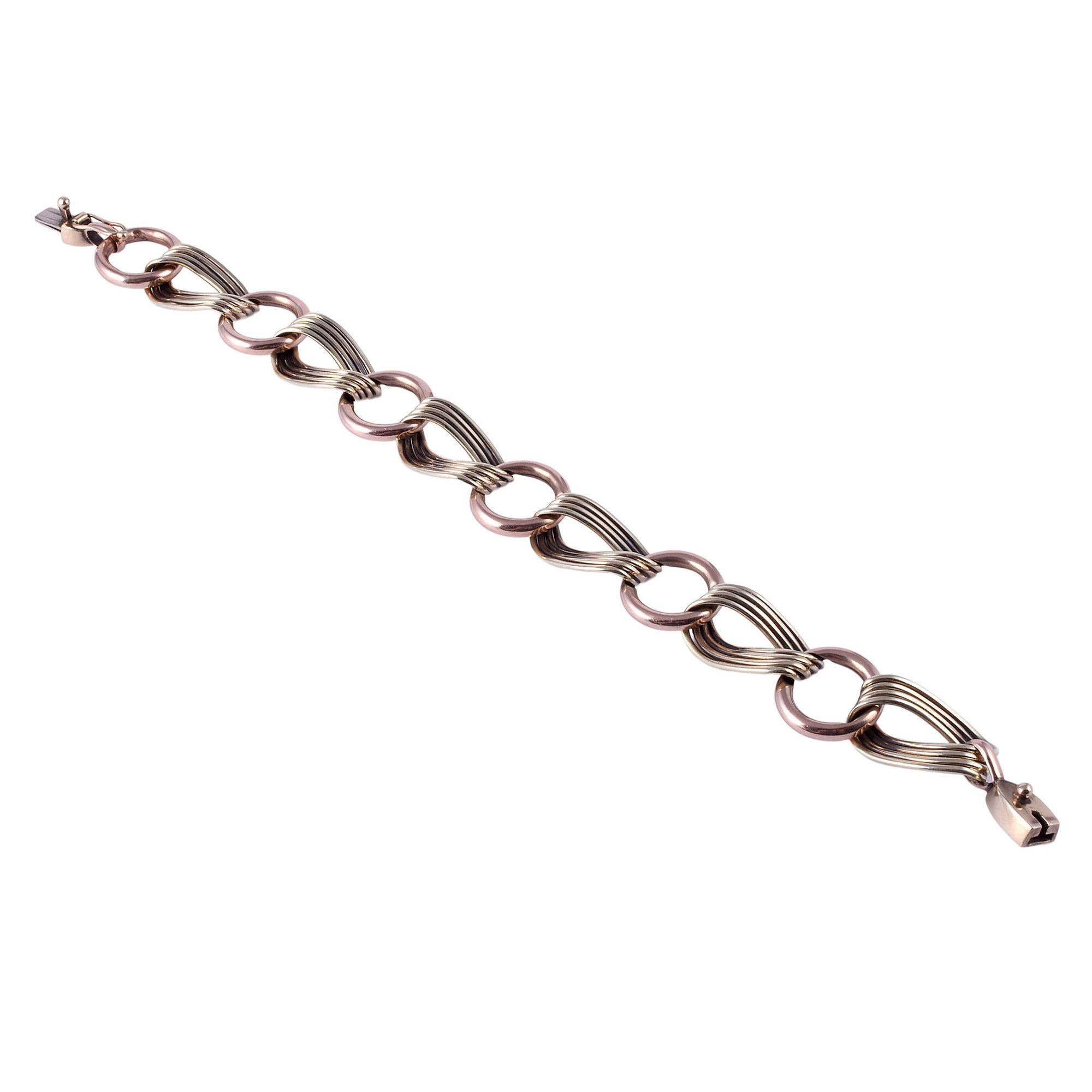 Antique rose & yellow gold link bracelet, circa 1900. This antique bracelet is crafted in 14 karat yellow and rose gold. The antique link bracelet weighs 24 grams. [KIMH 584]

Dimensions
7.875