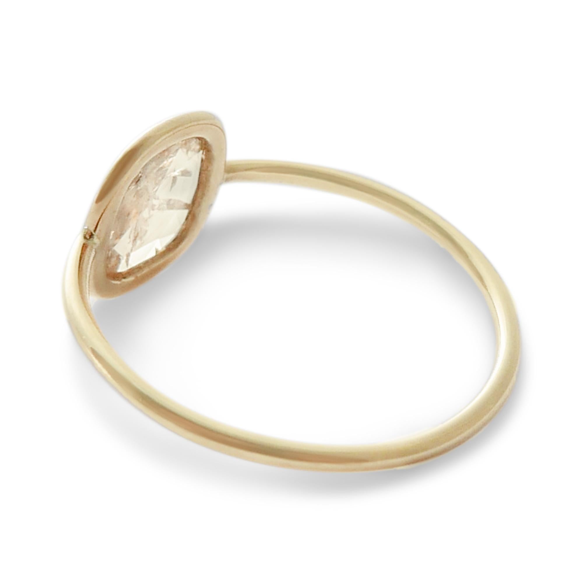 This diamond ring features a pale cognac squared-oval shaped rosecut diamond set in a 18-carat yellow gold bezel on a slim band.  Weighing approximately 0.8 carat, the diamond is a free-form rustic rosecut stone and therefore contains unique