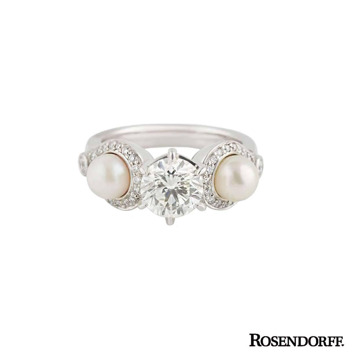 US size 4 5/8.  A beautiful 18k white gold diamond and pearl dress ring by Rosendorff. The ring is set to the centre with a 1.20ct round brilliant cut diamond, J colour and SI1 in clarity. The diamond is set in a six claw setting and is complemented