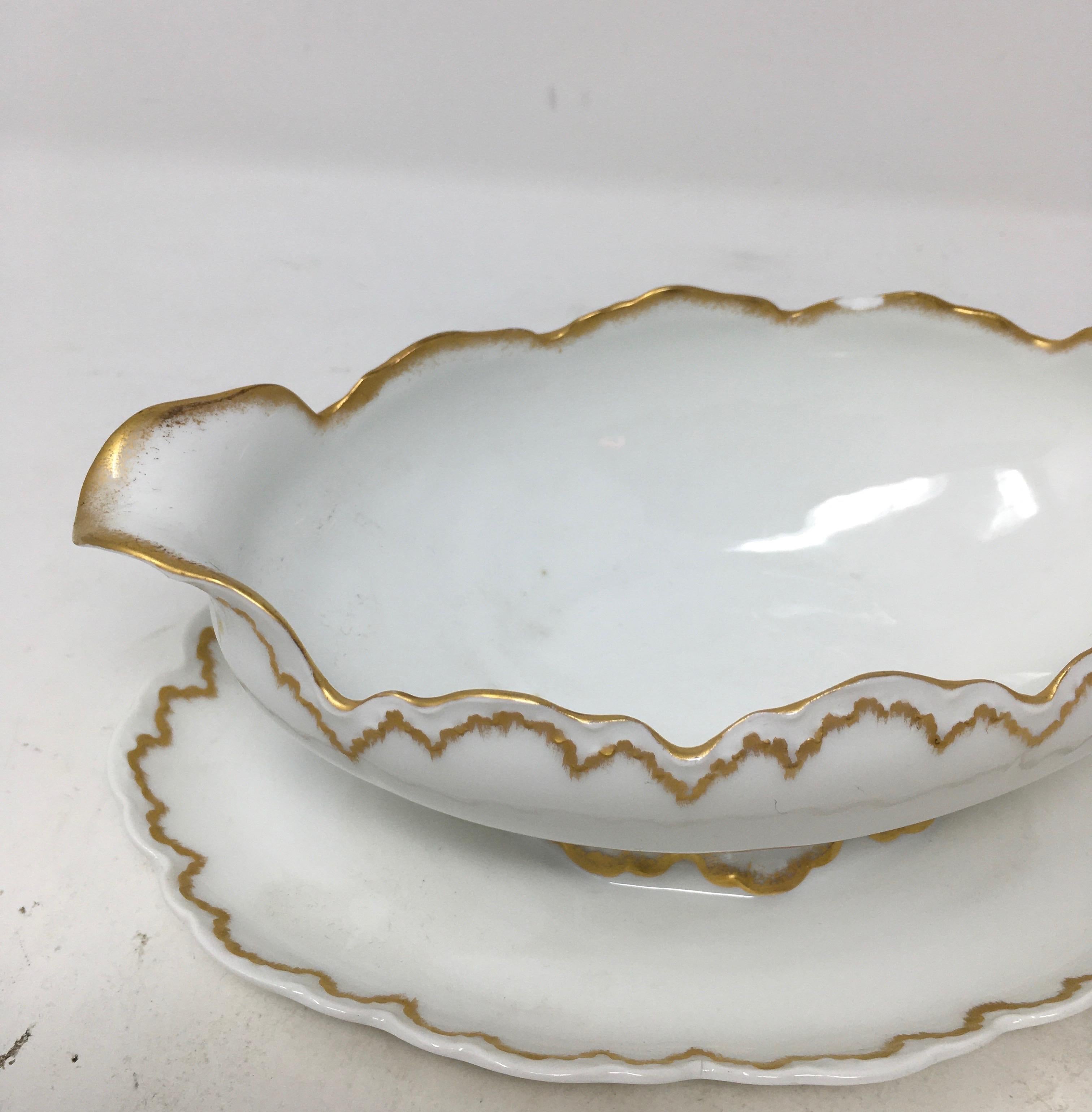 This is a lovely gravy or sauce with a gold scalloped edge and attached plate. The piece is marked on the bottom with the Rosenthal hallmark, Malmaison, Bavaria. A lovely piece for your entertaining needs.

This piece weighs 1 lb.
   