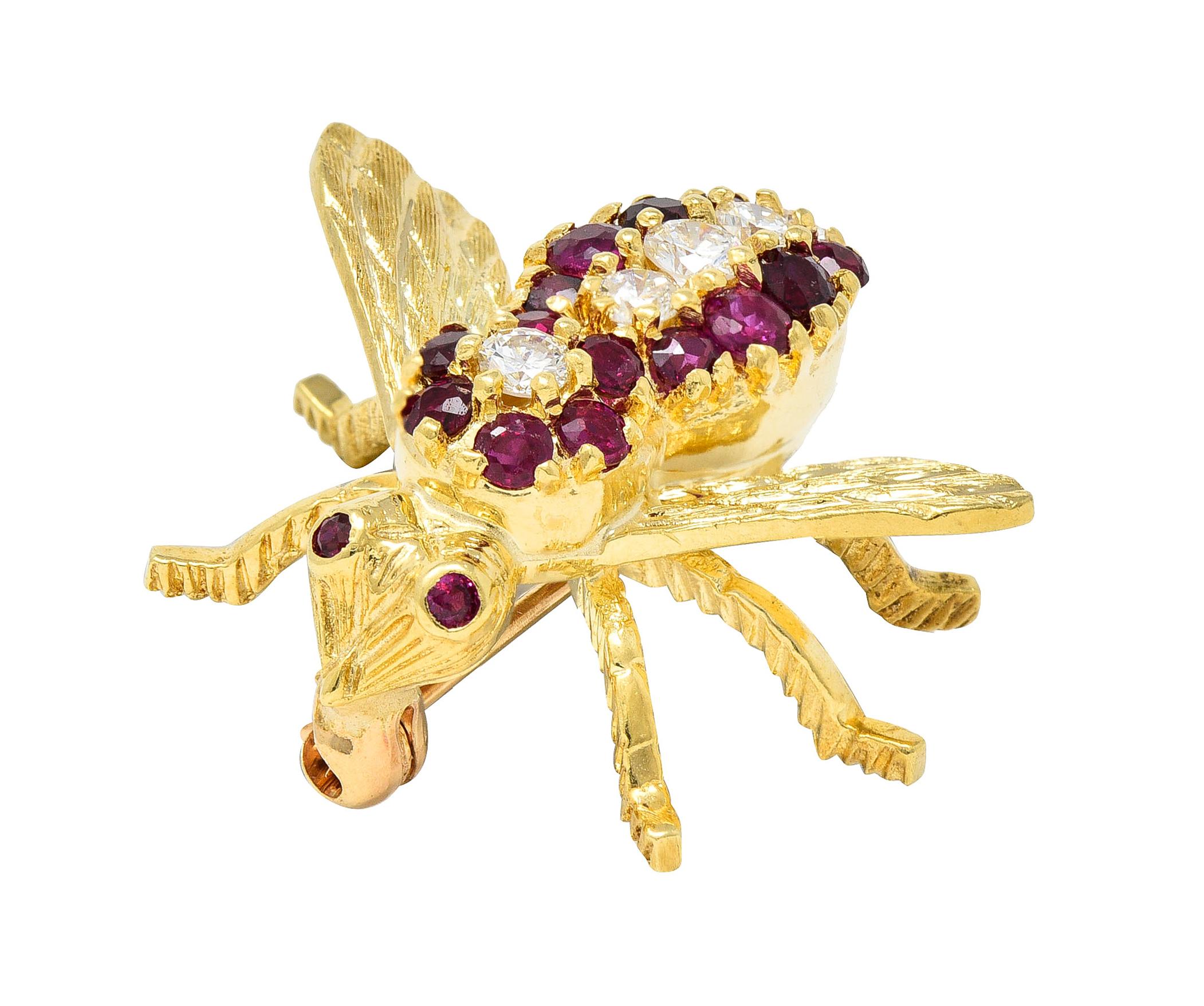 Designed as a stylized bee with linear engraved wings and textured legs
Featuring transitional cut diamonds prong set in a row along the back
Weighing approximately 0.26 carat total - G/H color with VS clarity
Flanked by two rows of round cut rubies