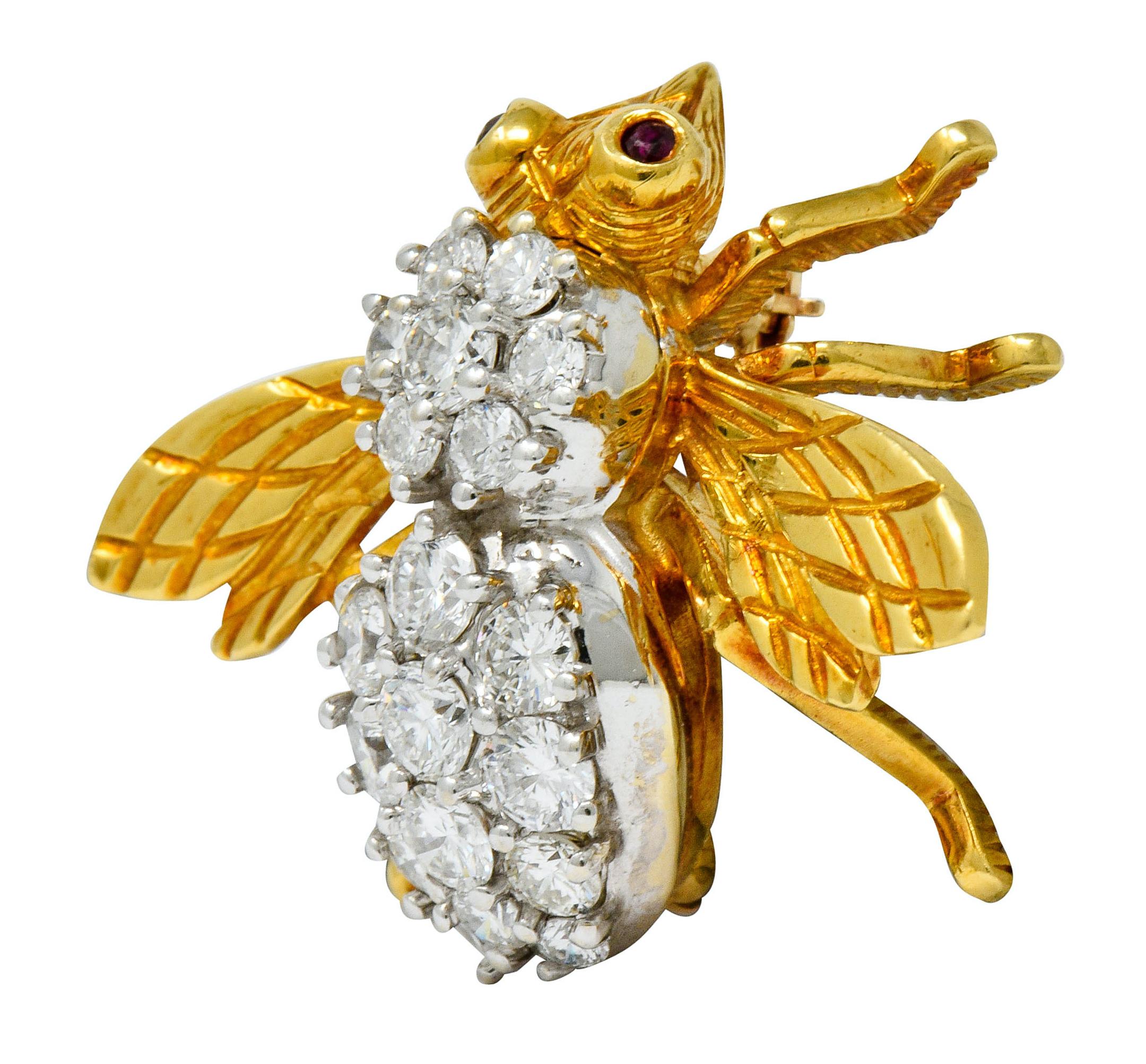 Designed as an insect with polished gold head and wings that are deeply engraved with a harlequin pattern

Round brilliant cut diamonds, set in platinum, weigh in total approximately 2.75 carats; G to I color with VS and SI clarity

Accented with