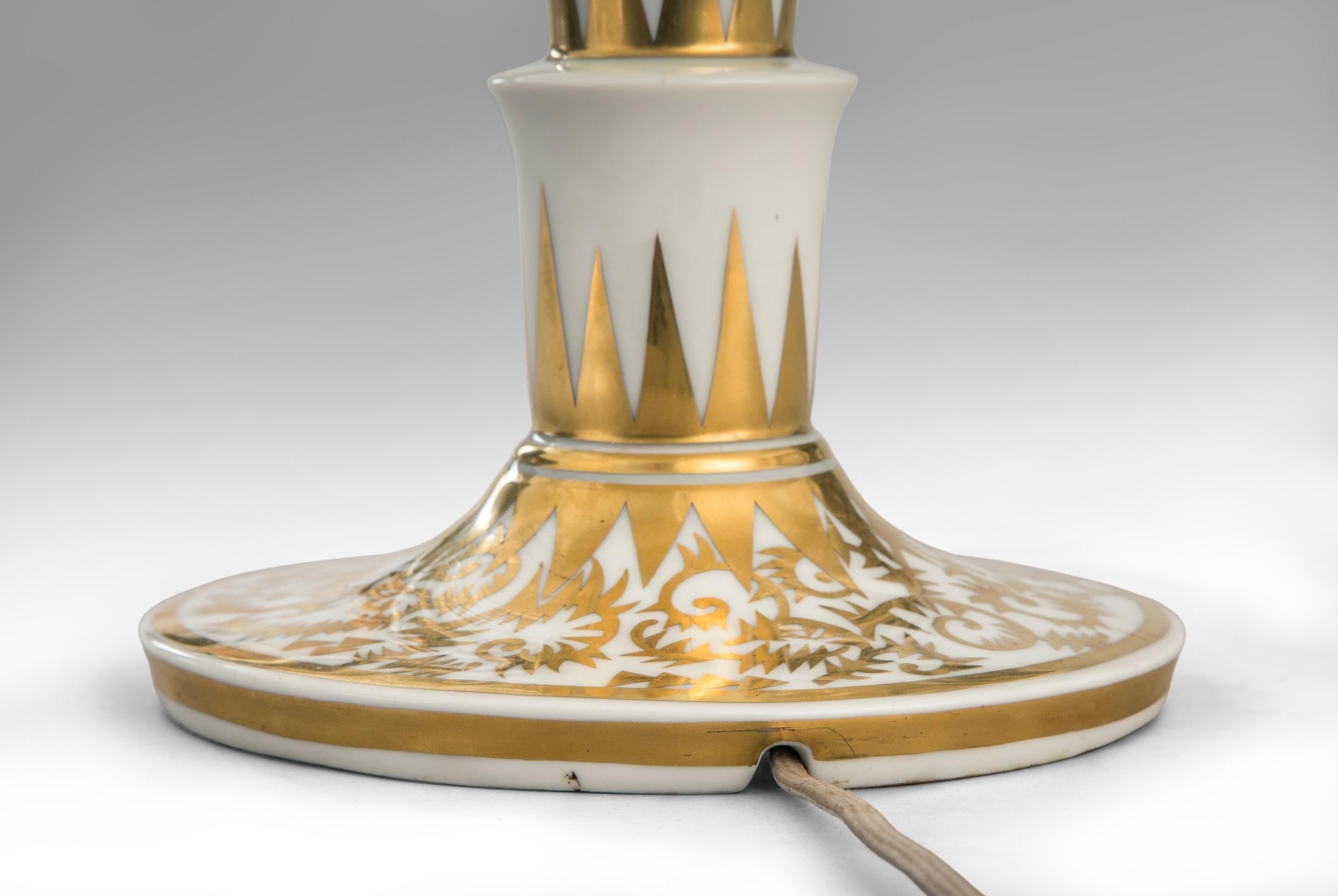 Rosenthal, a German parcel gilt porcelain lamp,
mid-20th century
A limited edition lamp by one of Europe's leading porcelain studios. A column of cascading tiers above the domed circular base, adorned by luxurious parcel gilt decoration in the