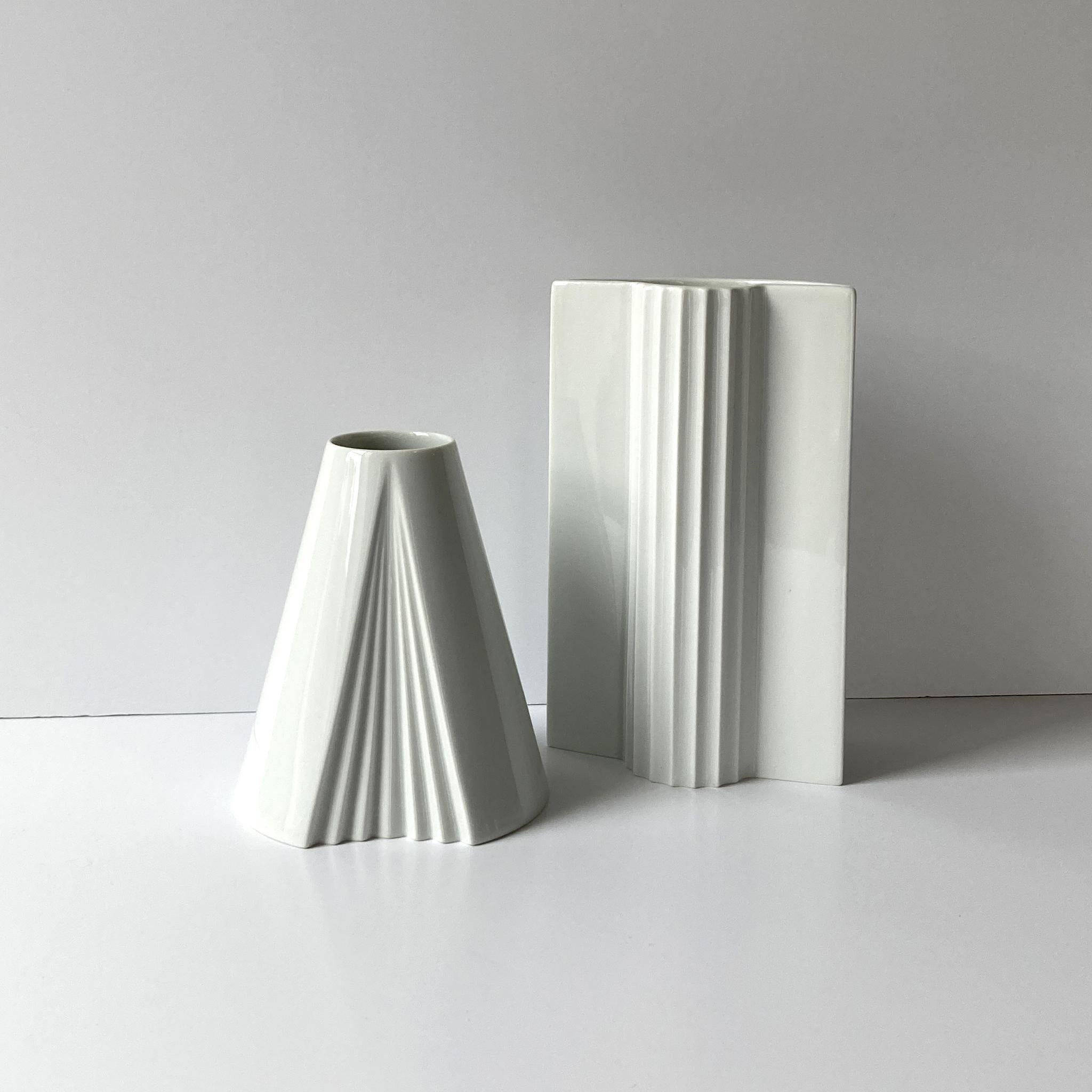 Pair of white vases including Thomas rounded pleat design and Rosenthal Plissee vase by Ambrogio Pozzi. The geometric shapes of this pair beautifully complement each other. 

Measurements: 
Thomas: H: 8